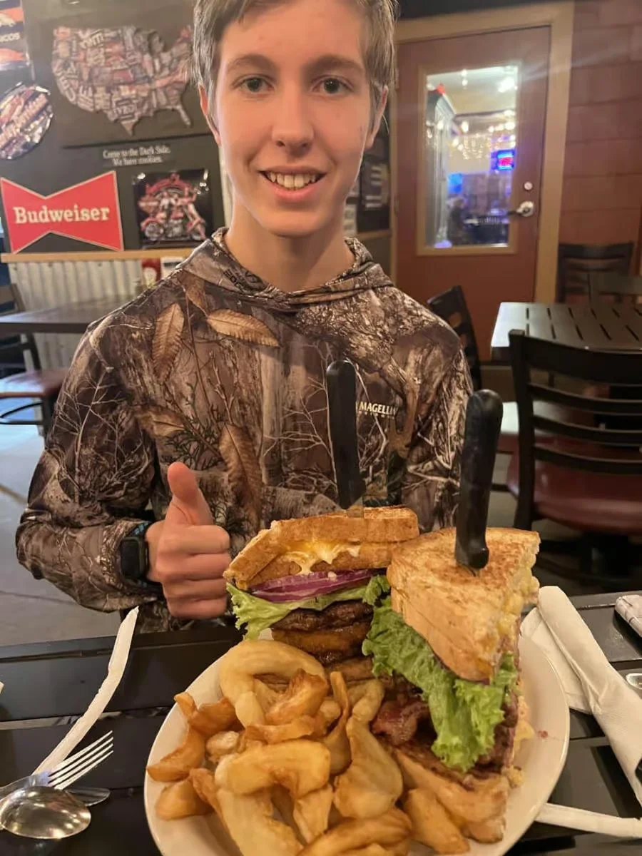 Giant American burger with fries in a casual dining setting