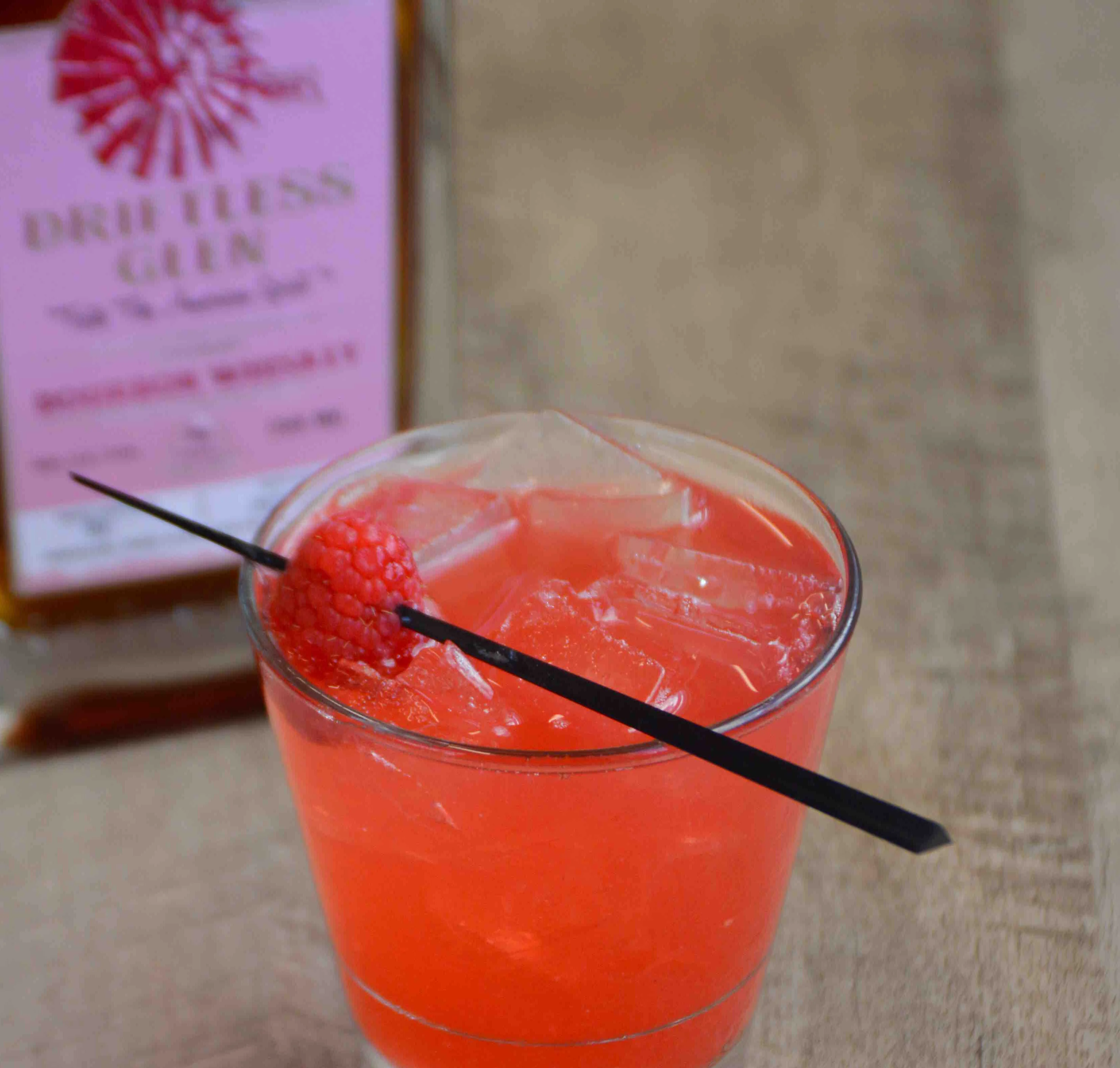 Pink for a Purpose sits by a bottle of exclusive pink-label bourbon