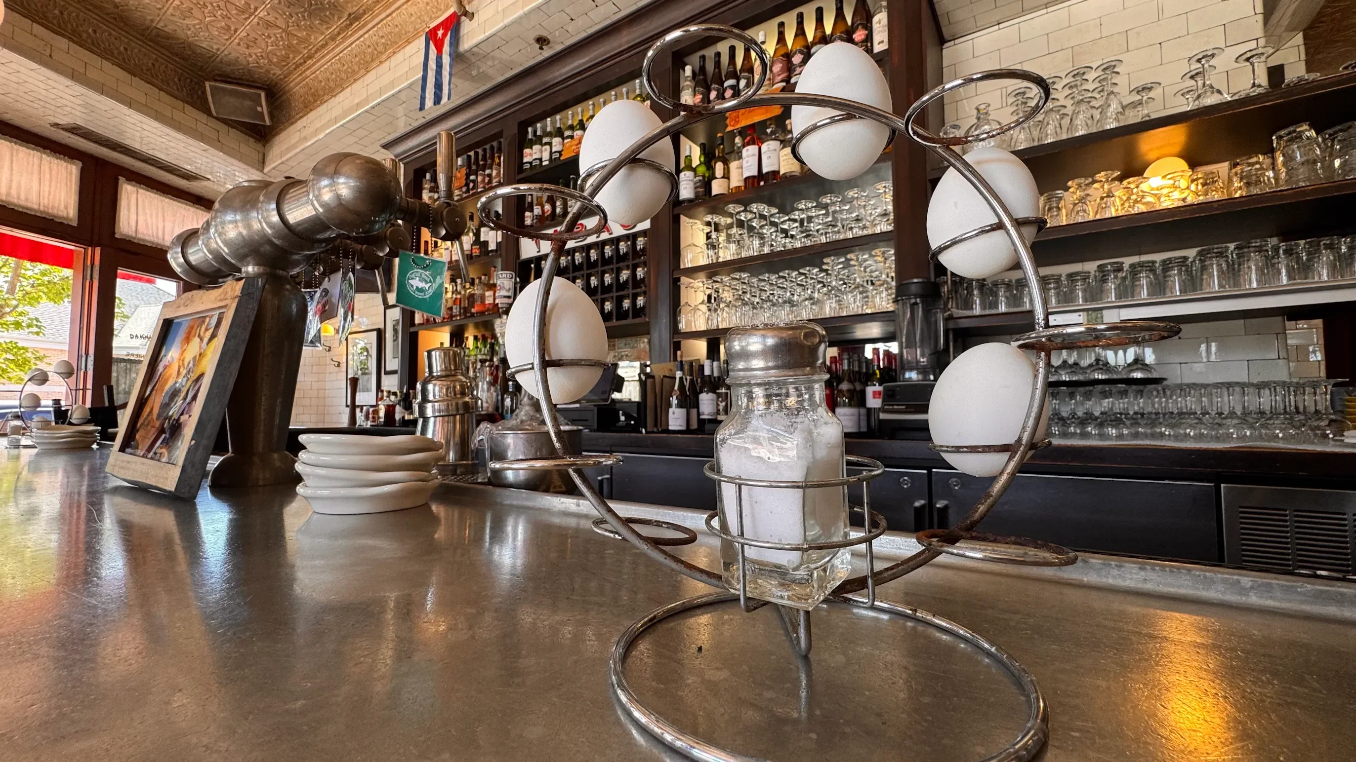 Stylish bar counter with unique egg holder and glassware in a restaurant setting