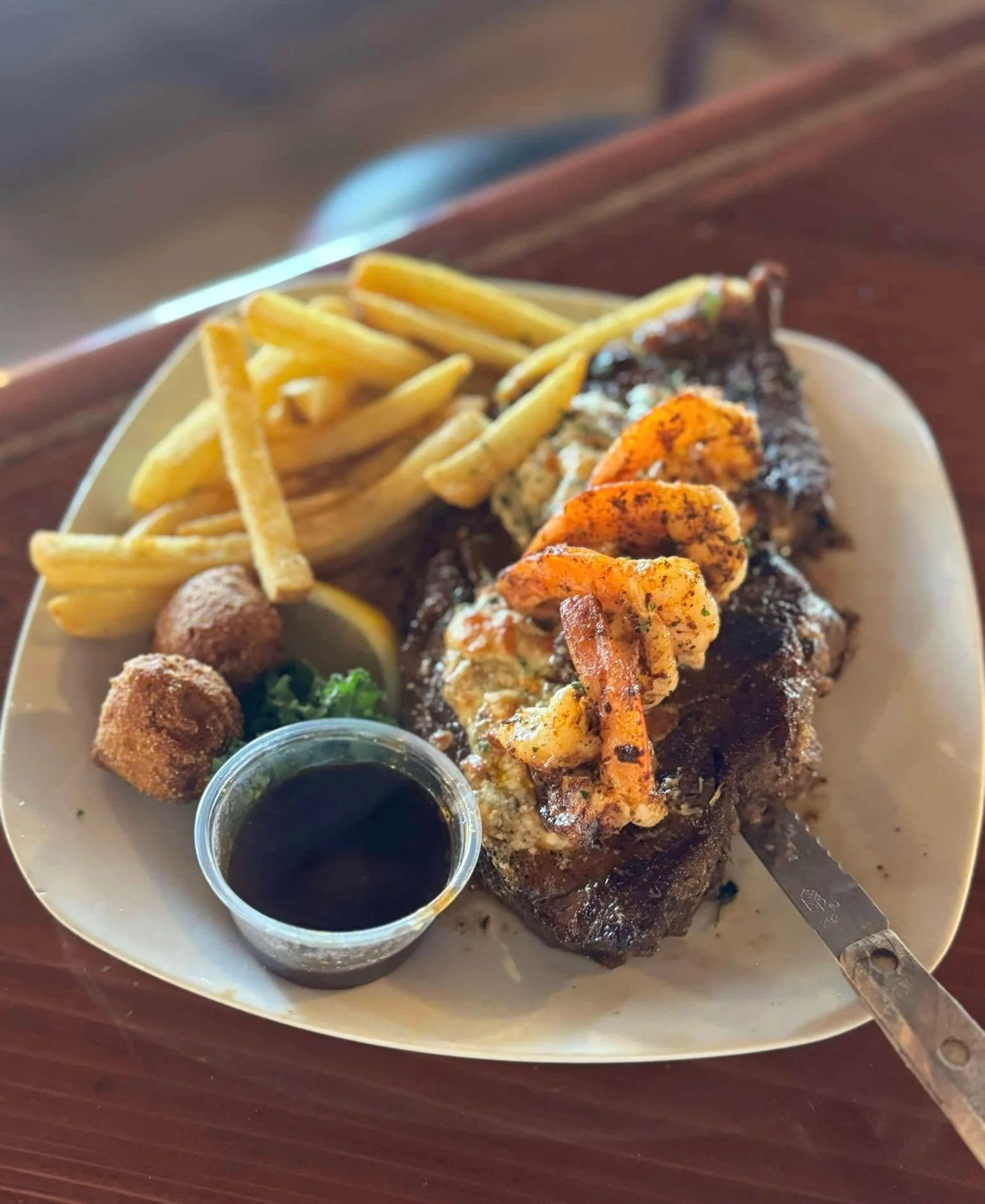 Grilled shrimp and steak platter with fries