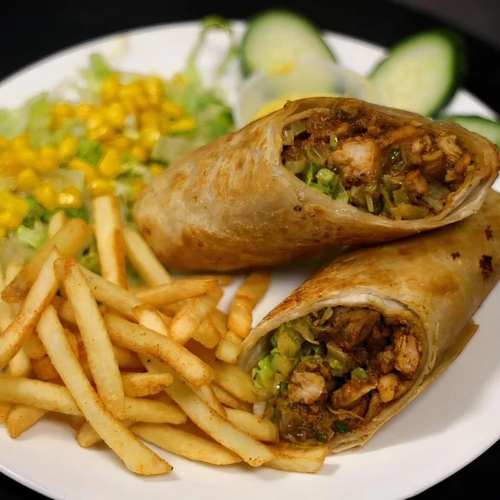 Delicious chicken burrito with fries and fresh salad