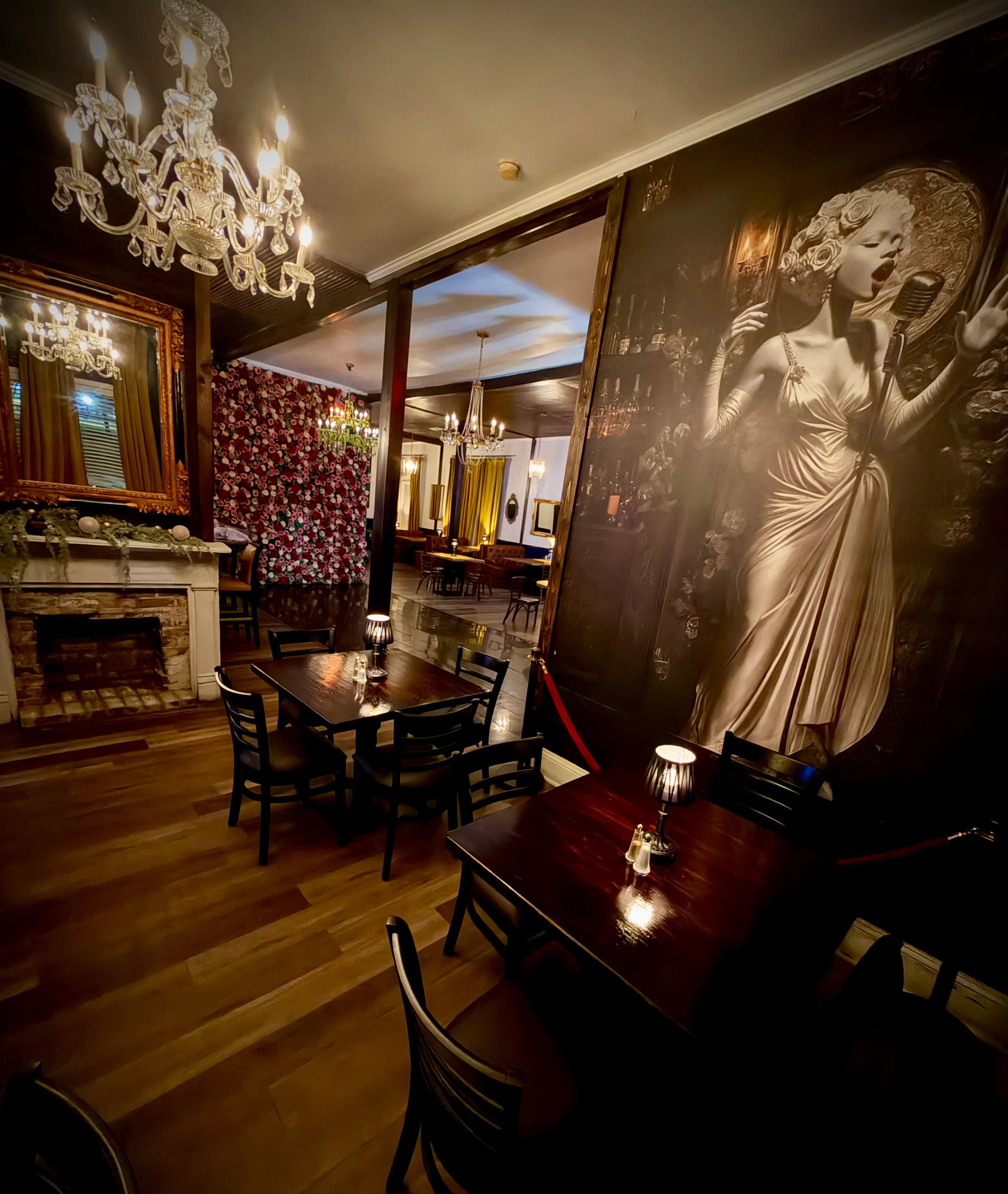 Elegant restaurant interior with vintage decor and artistic wall mural