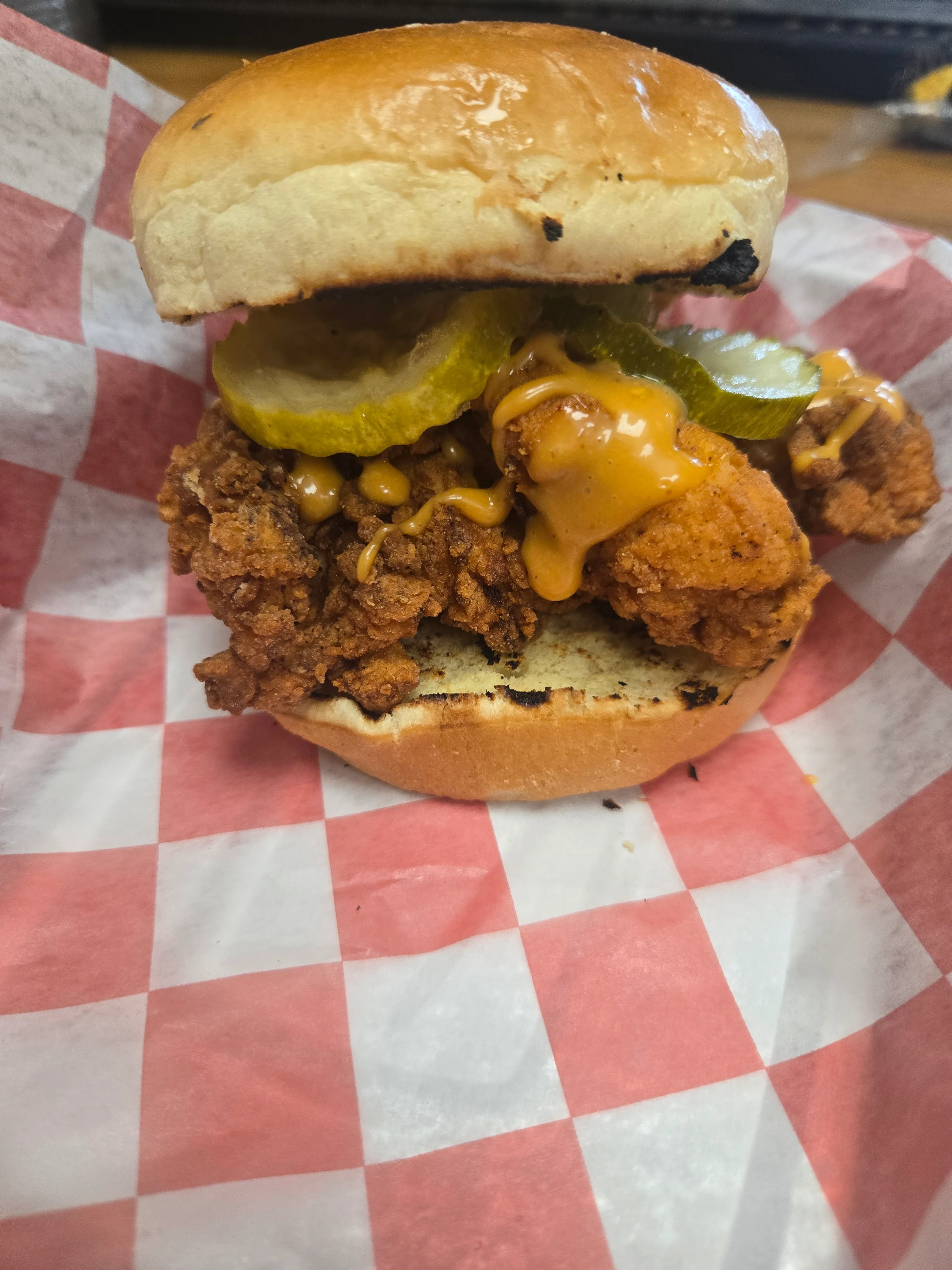 Crispy fried chicken sandwich with pickles and sauce