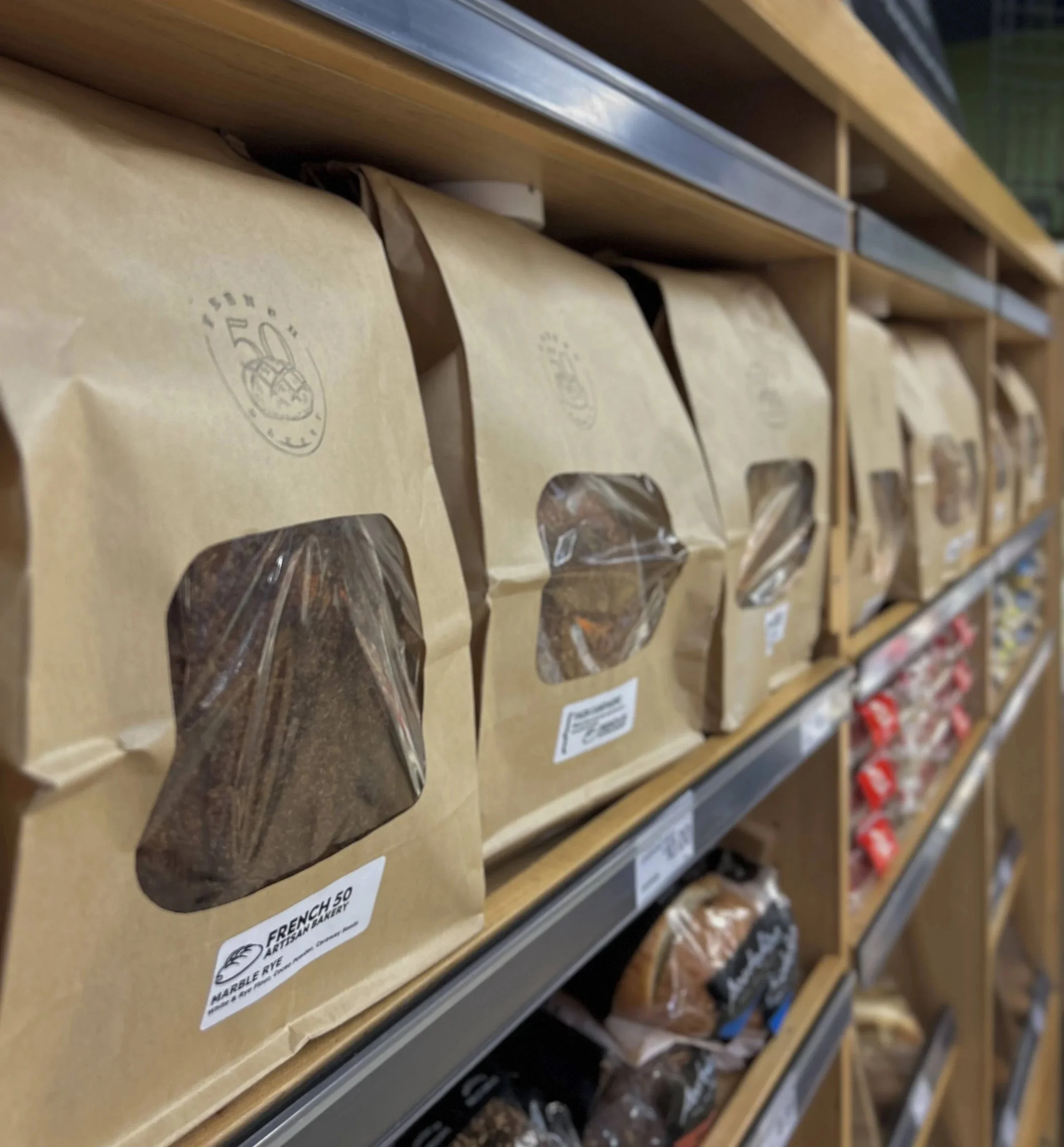 Artisan bread packages on a wooden shelf