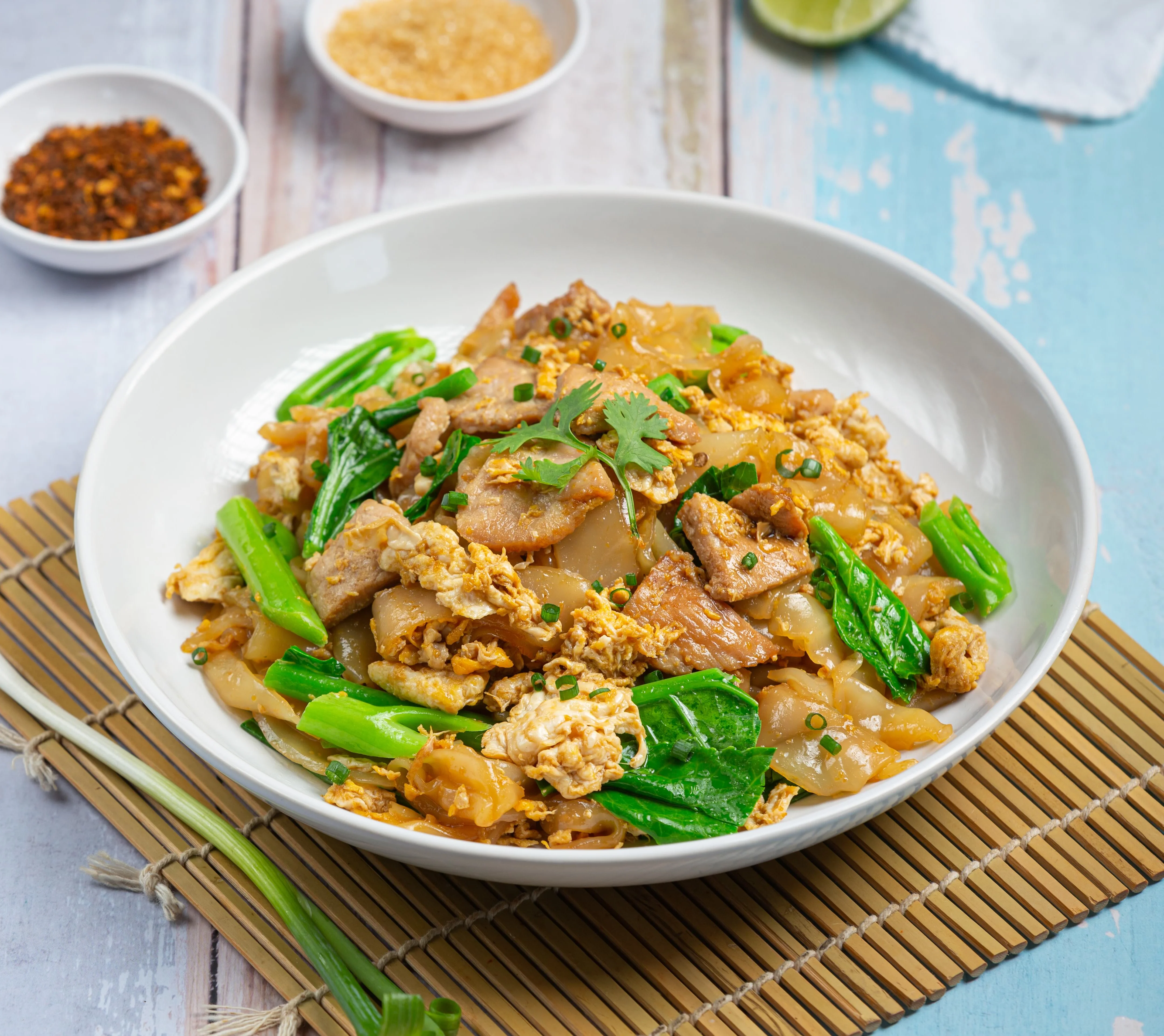 Plate of Thai pad see ew with chicken and vegetables