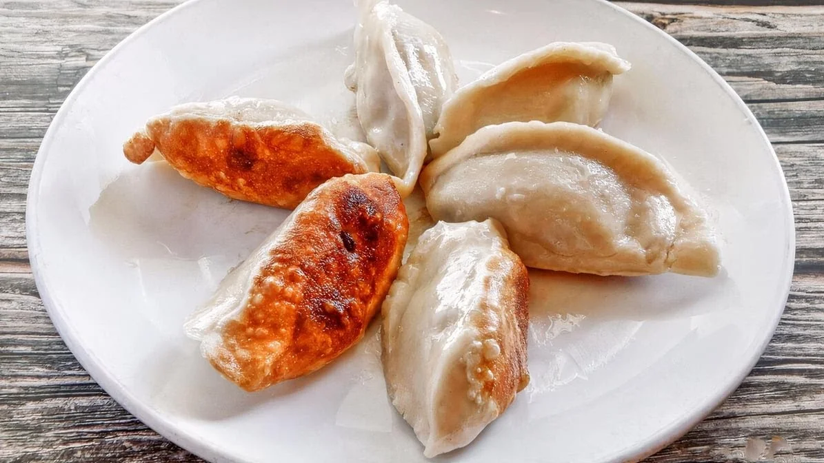 Plate of Chinese potstickers with crispy edges