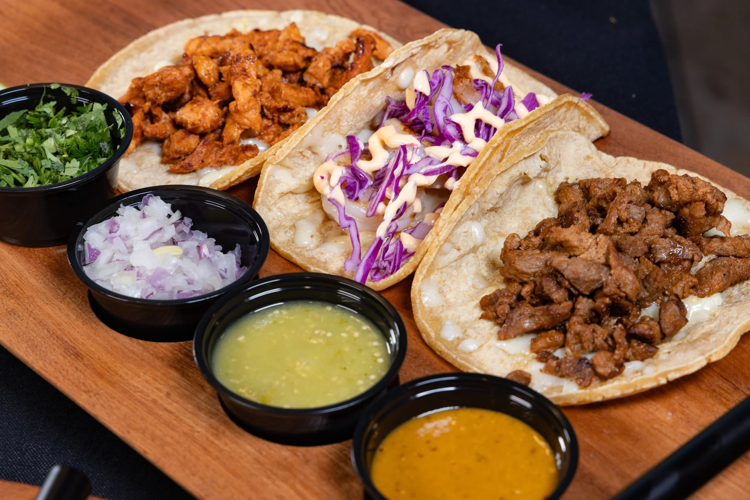 Three delicious tacos with various fillings and toppings