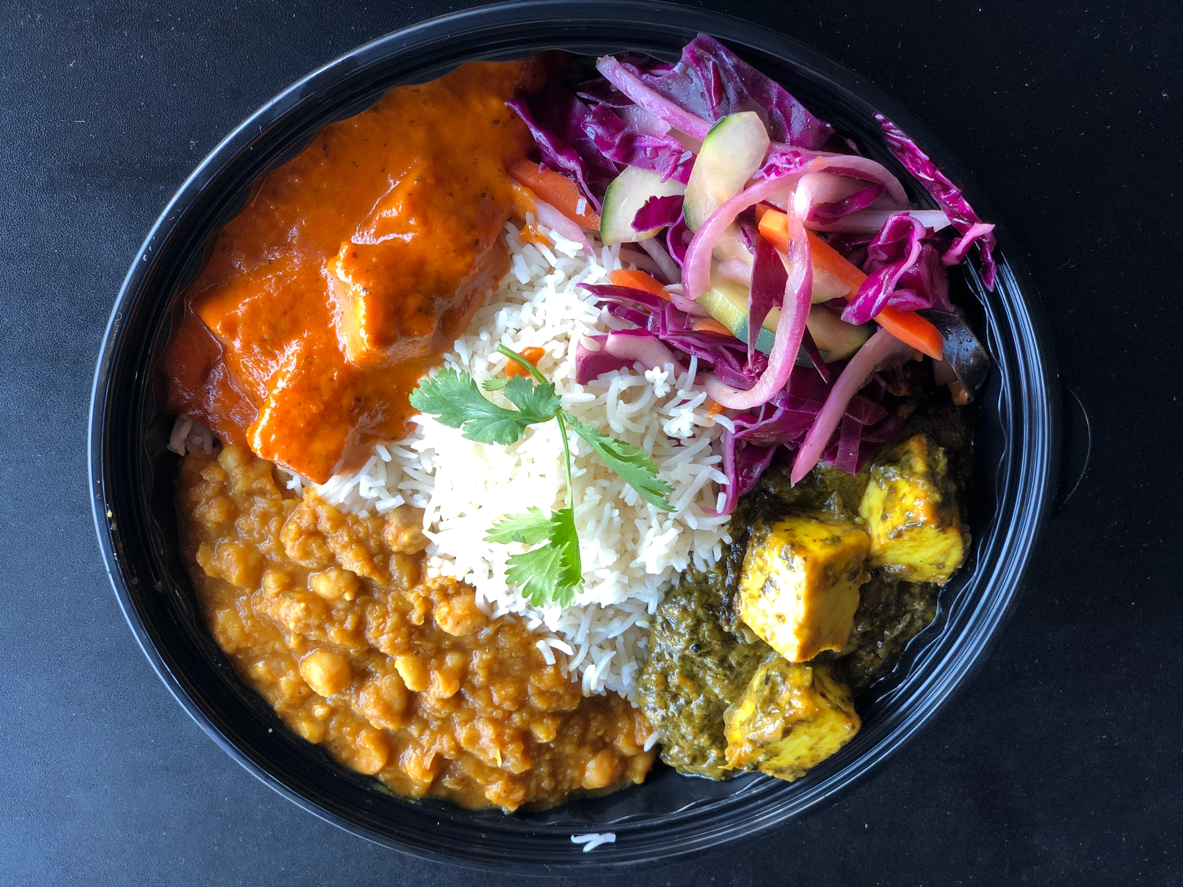 Indian thali with butter chicken, dal, rice, and salad