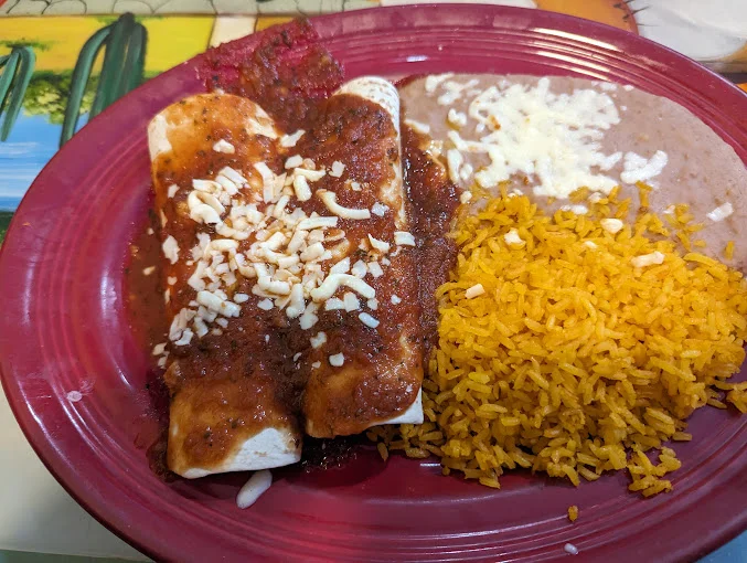 Plate of enchiladas with rice and beans, a classic Mexican dish