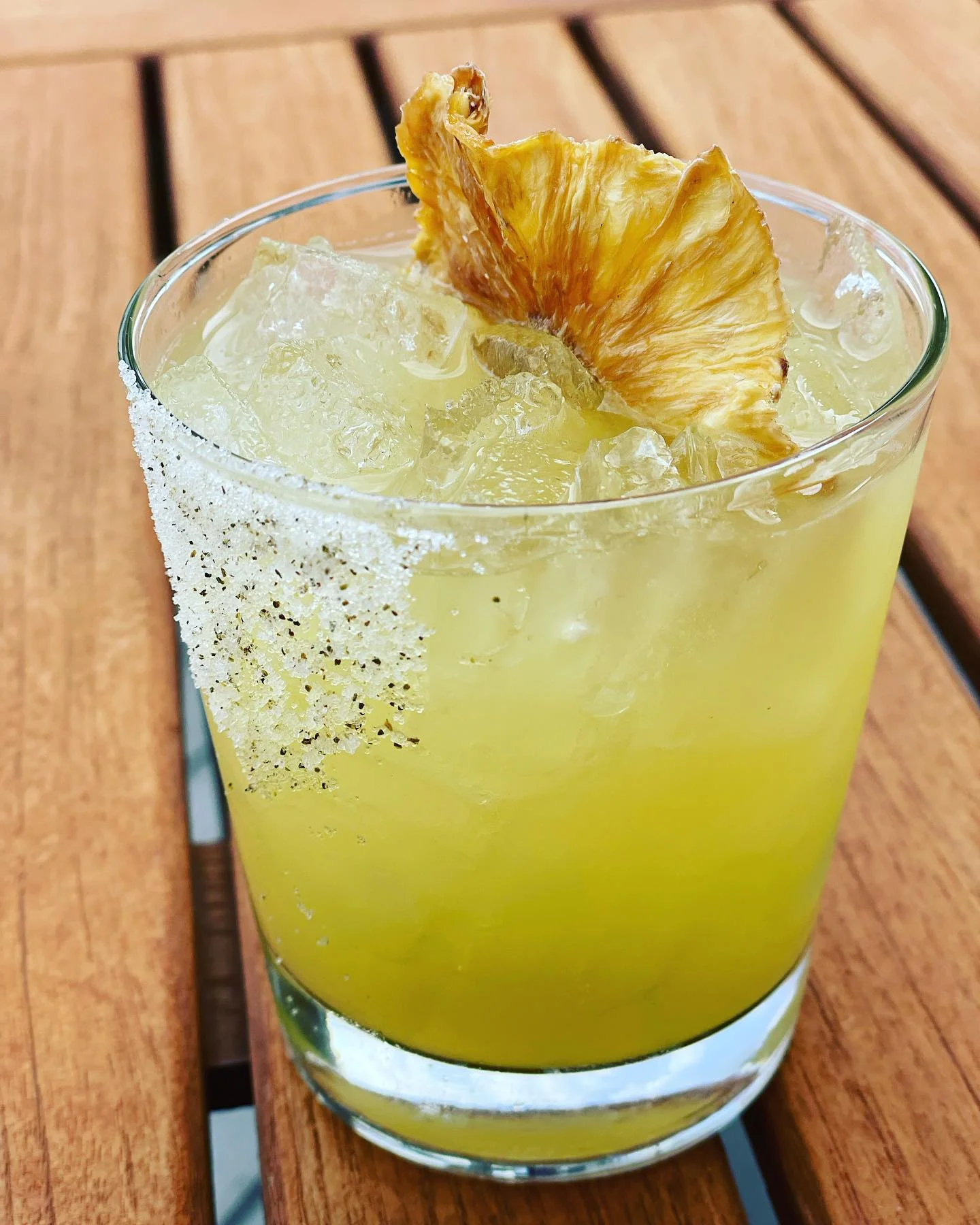 Refreshing tropical cocktail with dried pineapple garnish