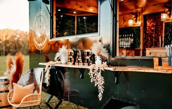 Stylish mobile bar setup with rustic decor and seating