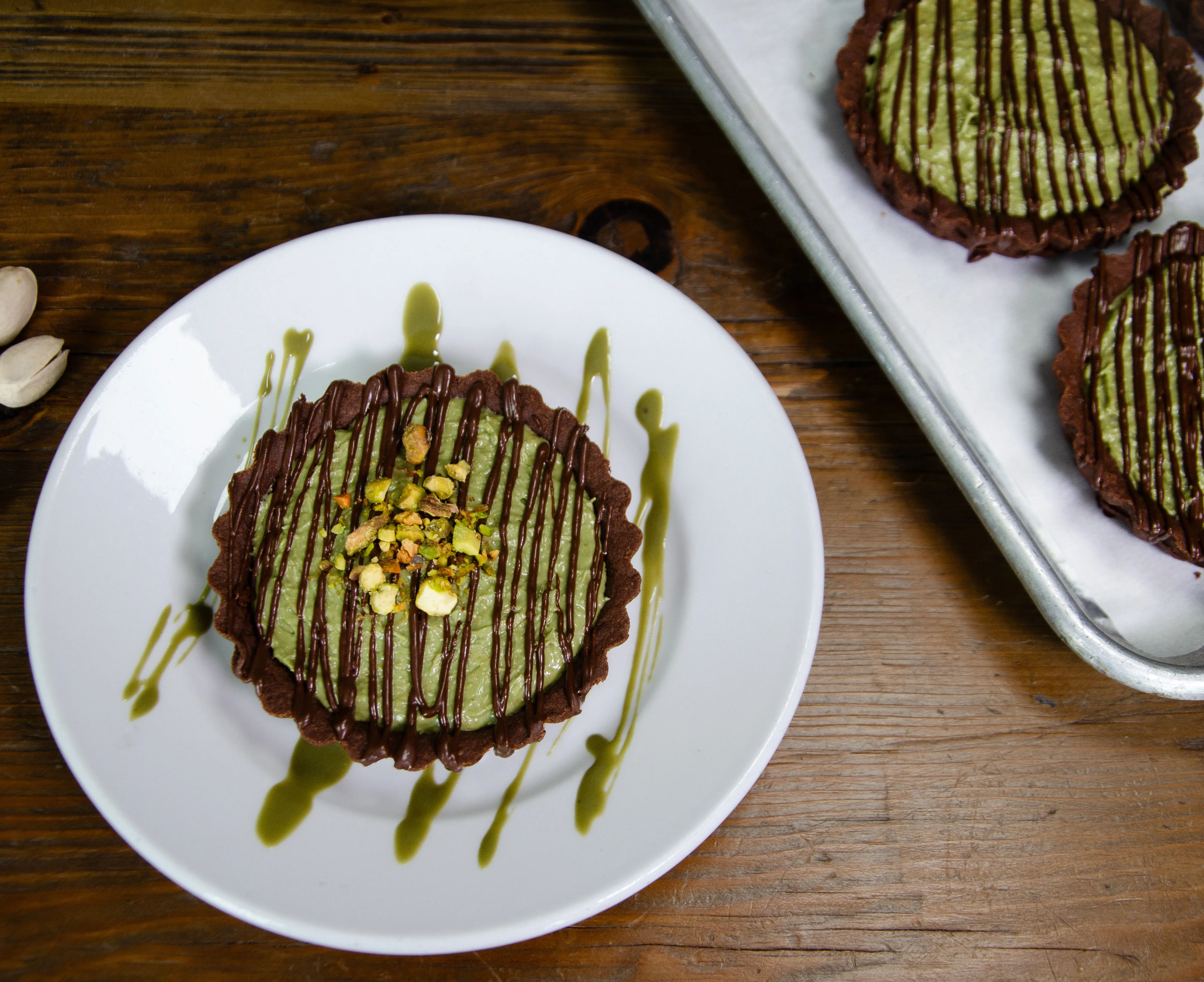 Matcha tart with chocolate crust and pistachios