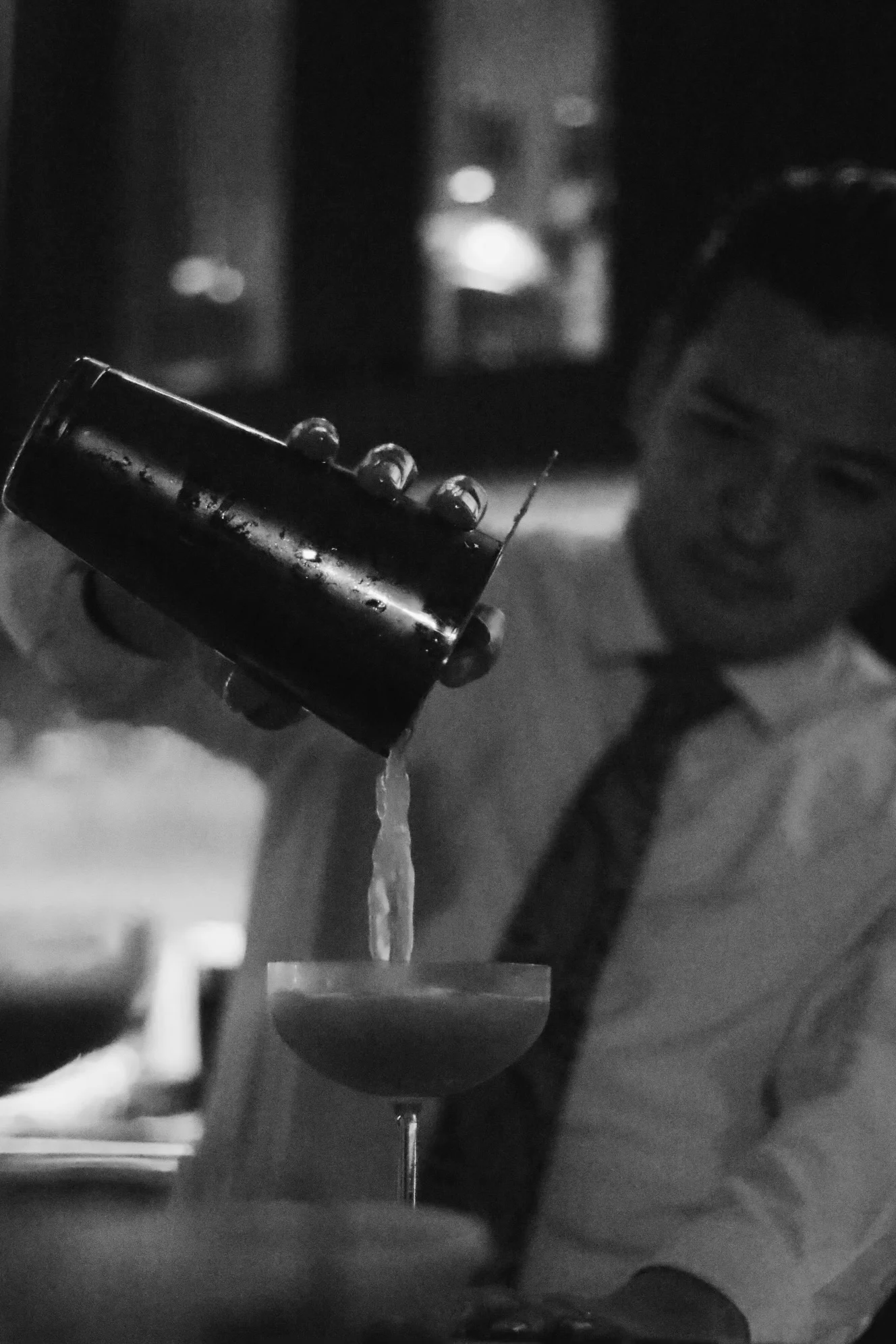 Bartender pouring a cocktail at a stylish bar