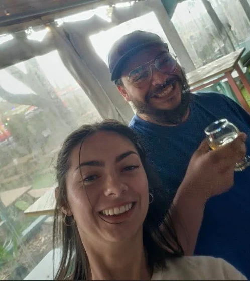 Two friends enjoying drinks in a cozy restaurant setting