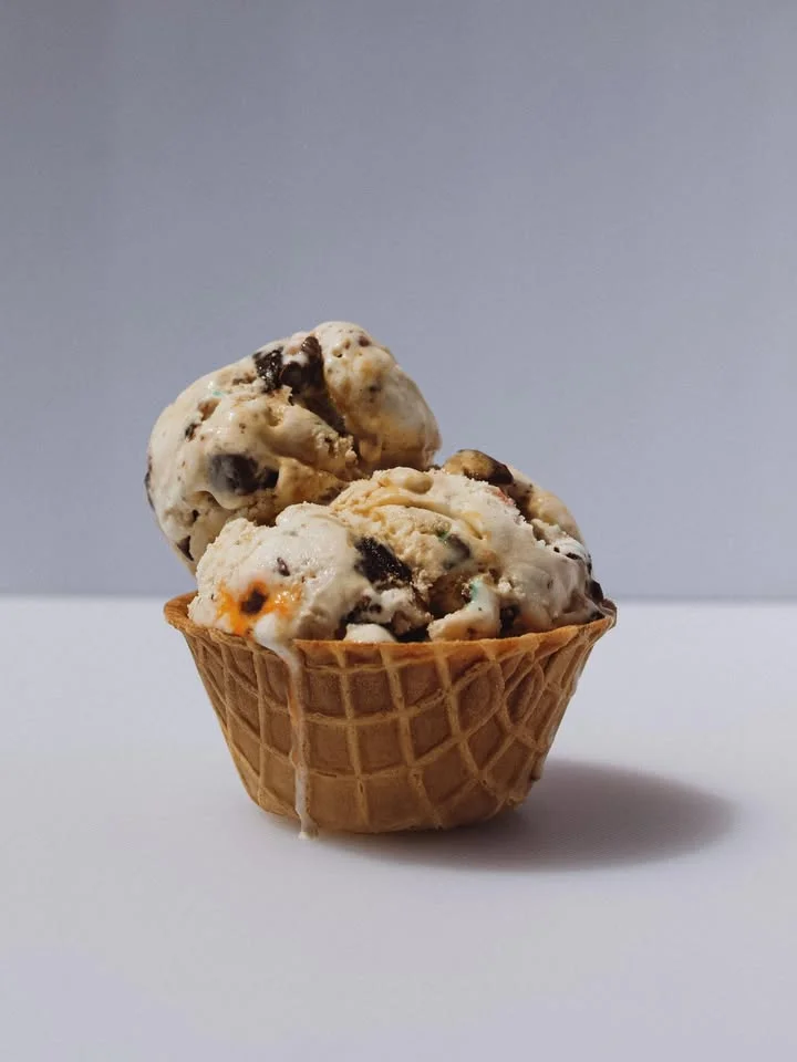 Delicious ice cream cone with mixed flavors