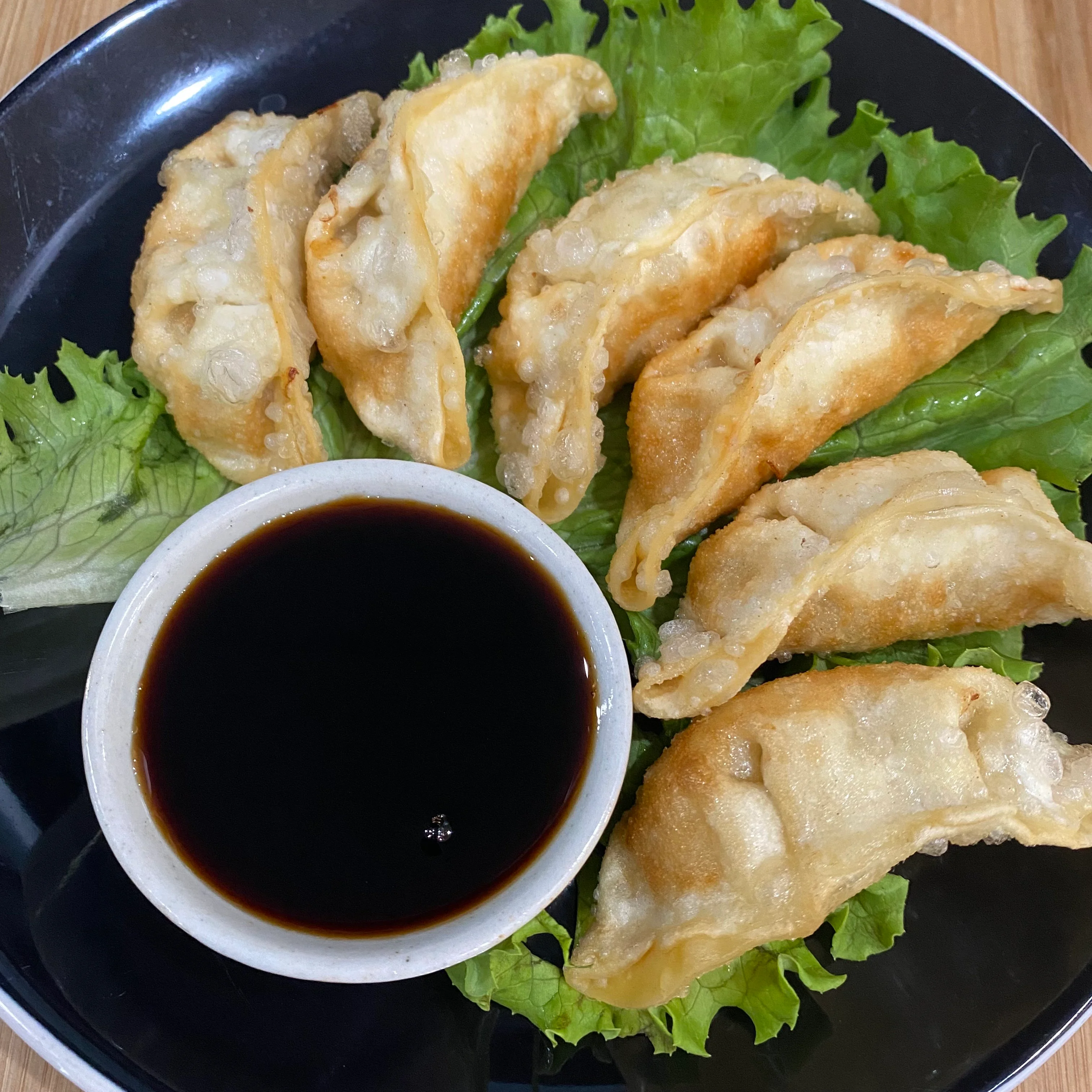 Crispy Chinese potstickers served with soy sauce