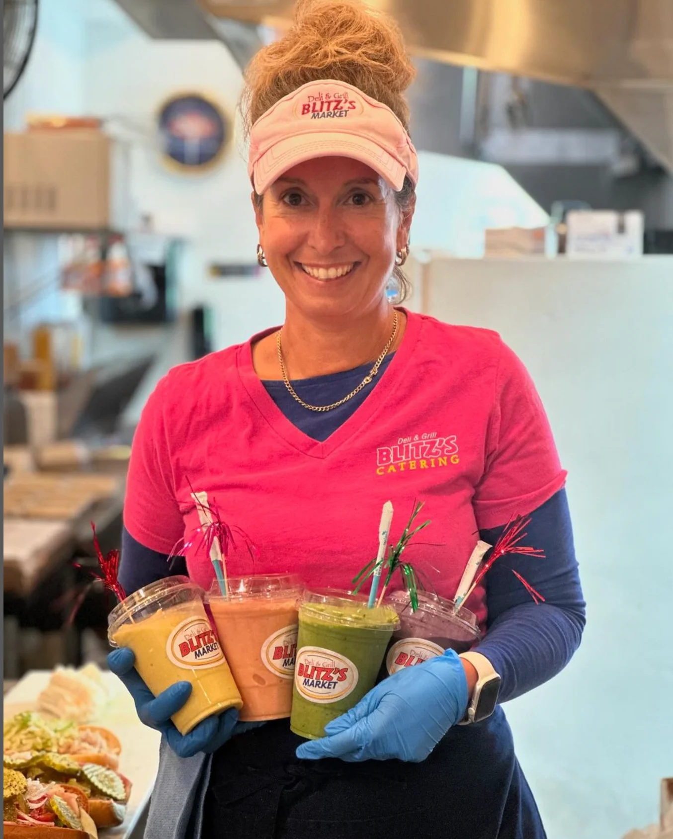 Catering staff with colorful smoothies at a deli