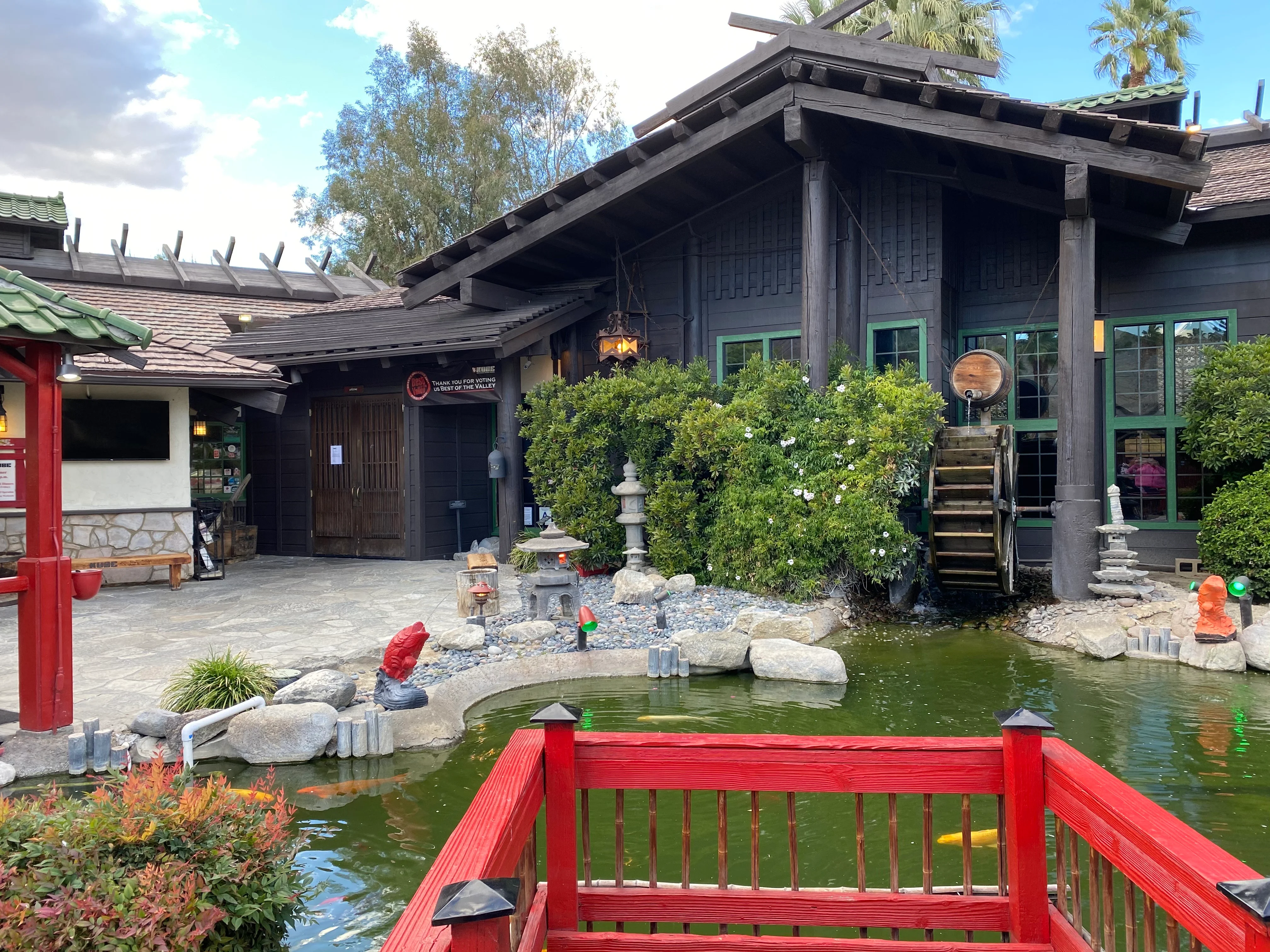 Charming restaurant exterior with a pond and traditional architecture