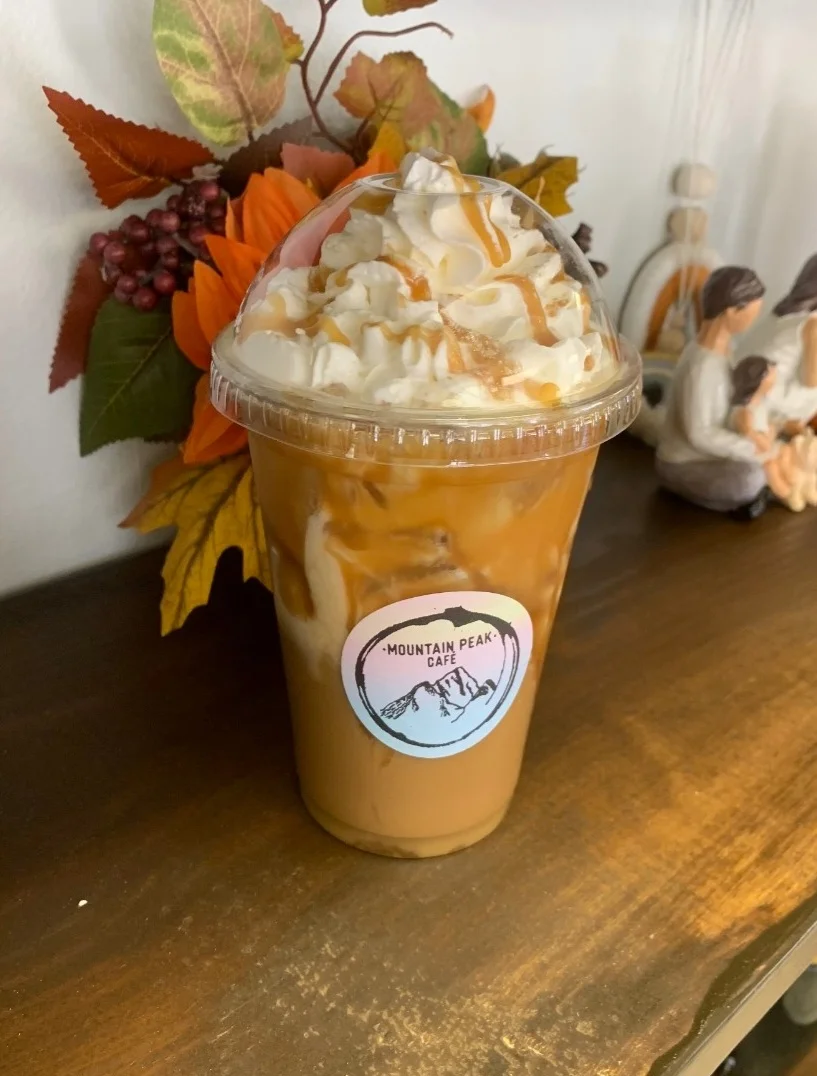 Iced caramel macchiato topped with whipped cream