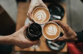 Coffee cups clinking together in celebration