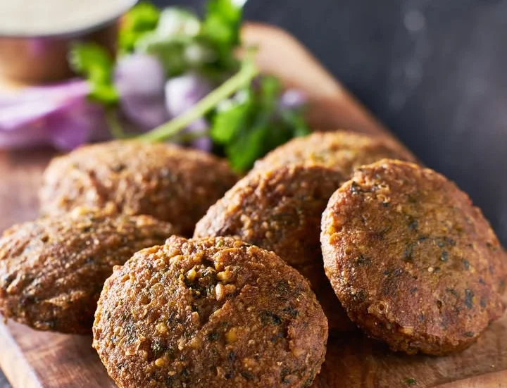 Crispy falafel served with fresh herbs and dipping sauce