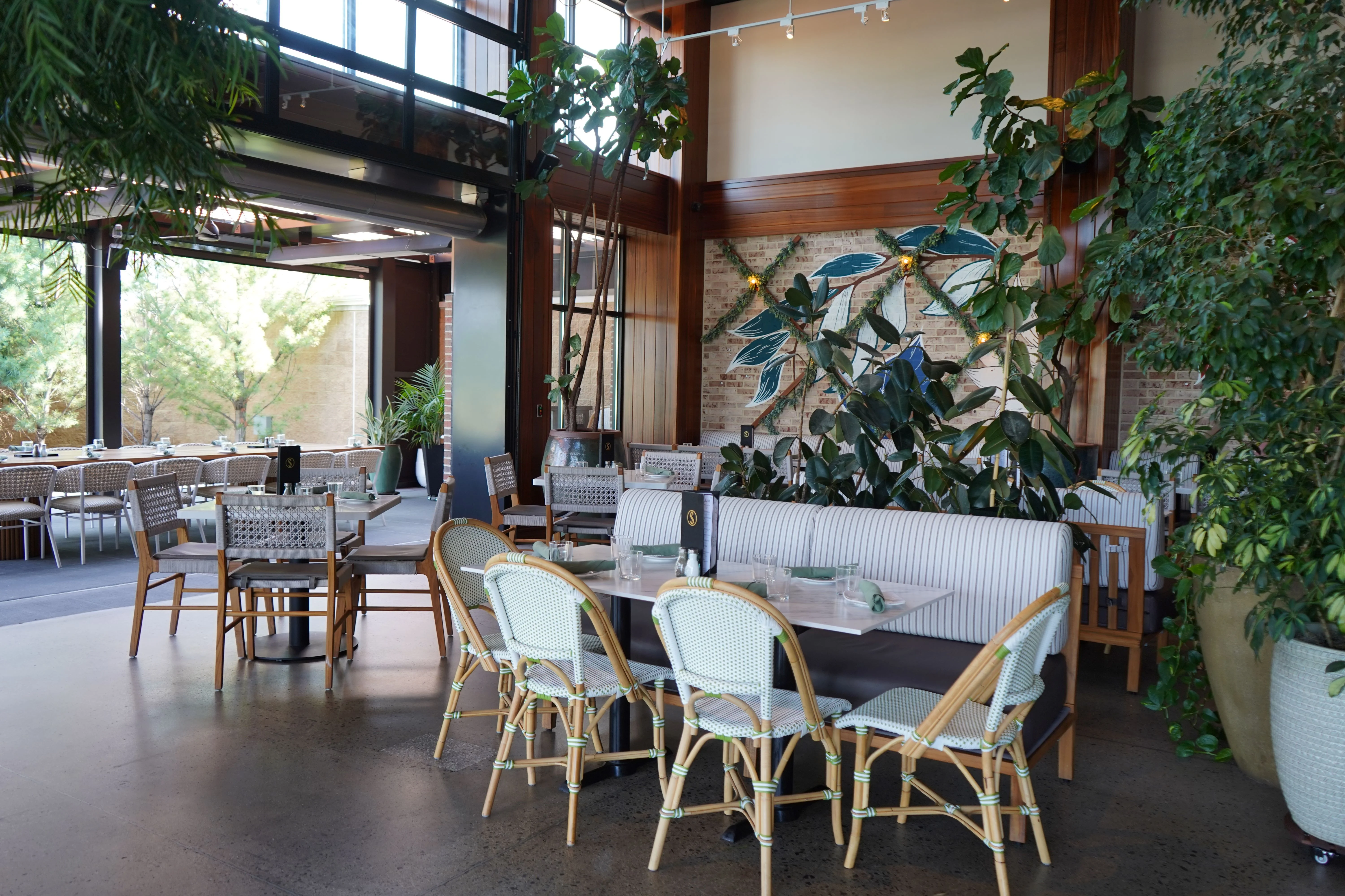 Stylish restaurant interior with greenery and modern decor