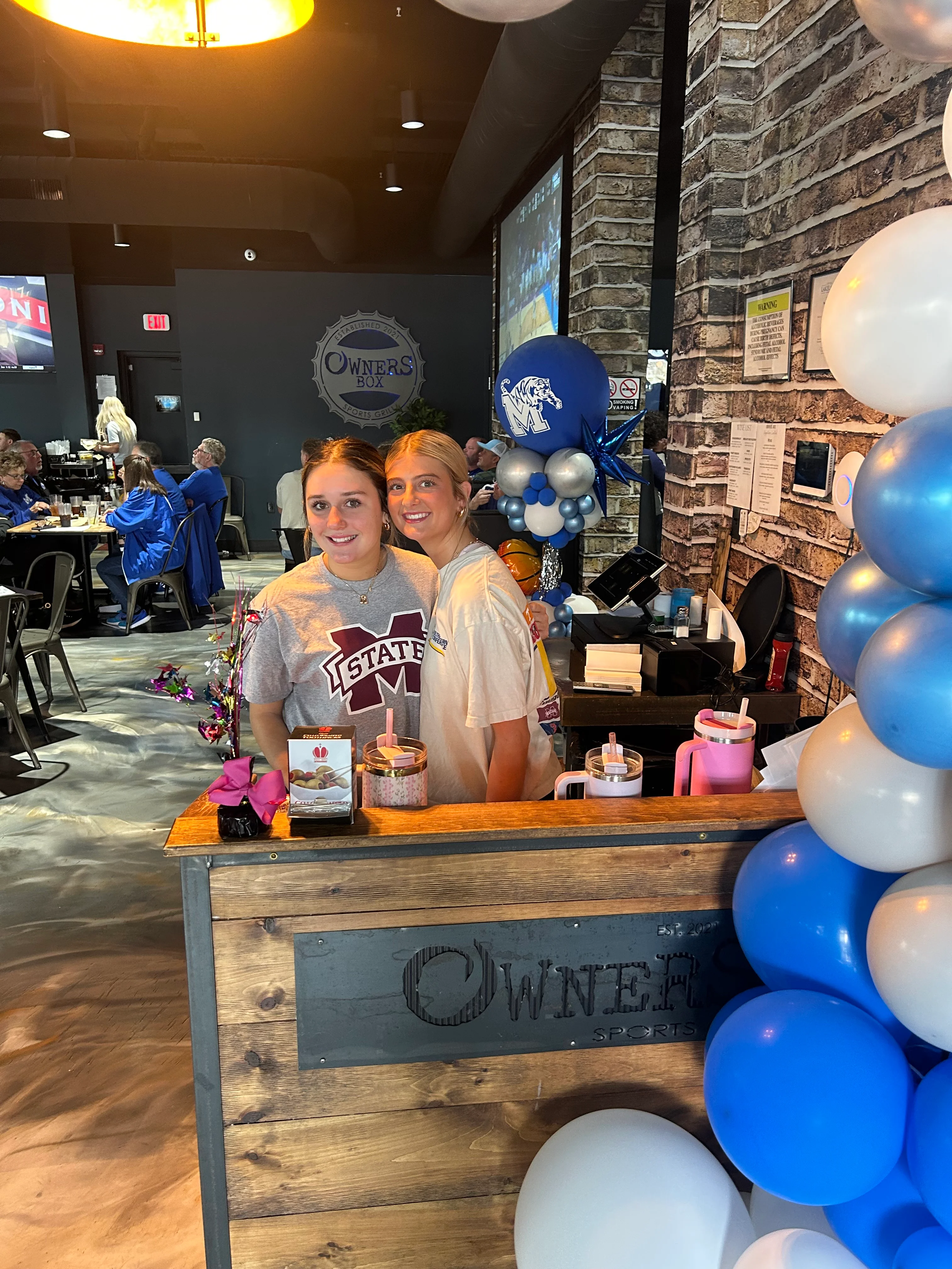 Friendly staff at Owners Box restaurant with festive decor