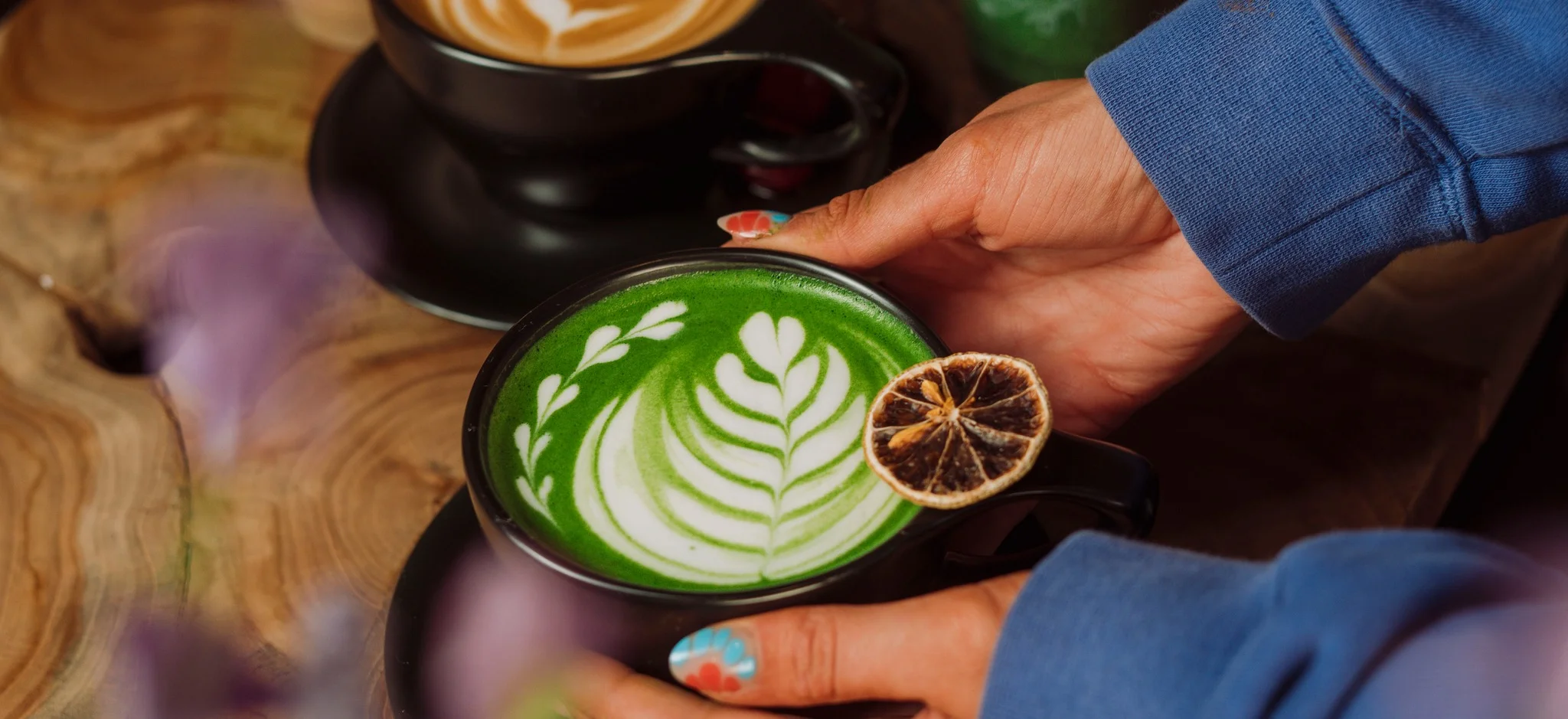 Artisan matcha latte with latte art and dried citrus garnish