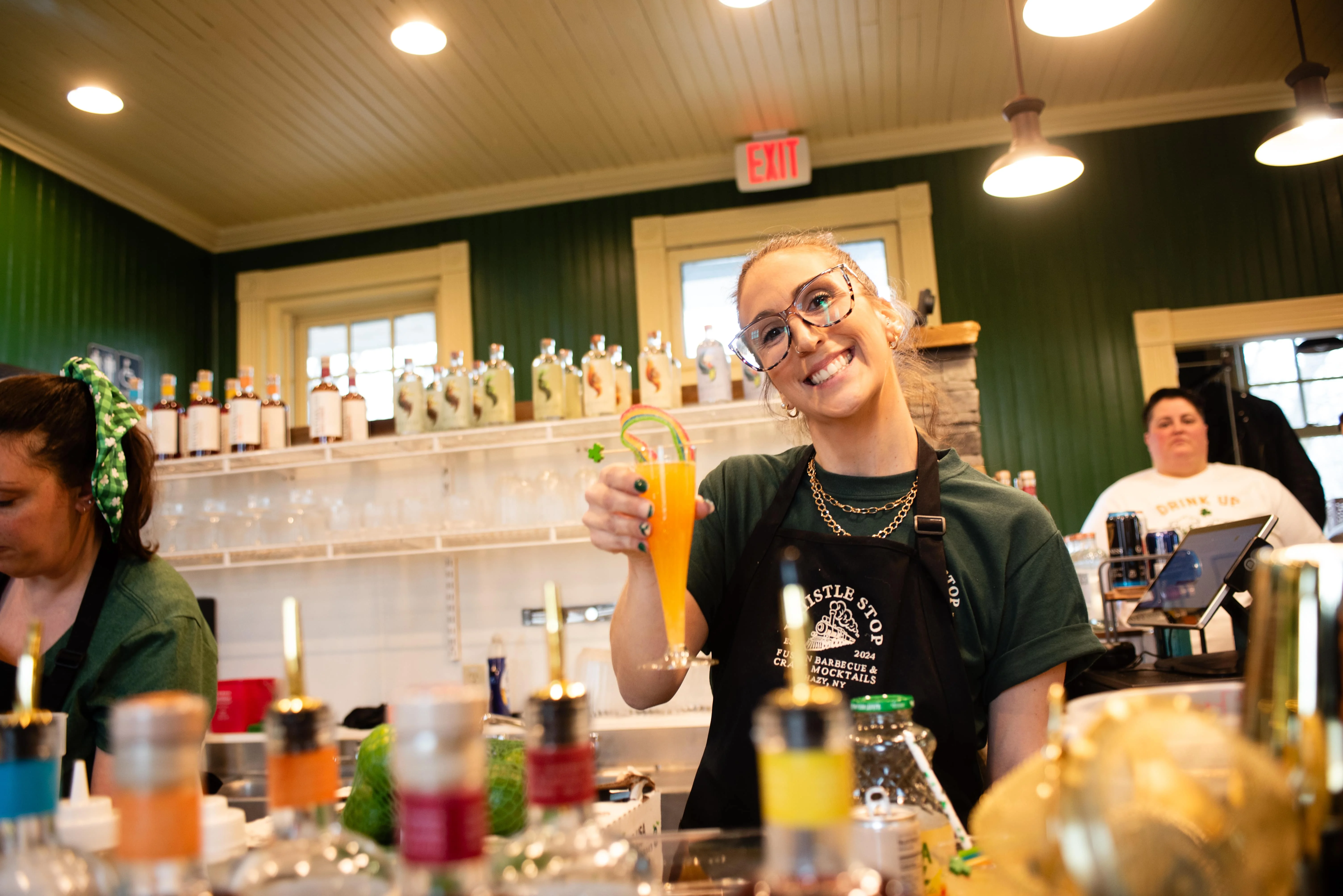woman serving mock mimosa with rainbow candy topper