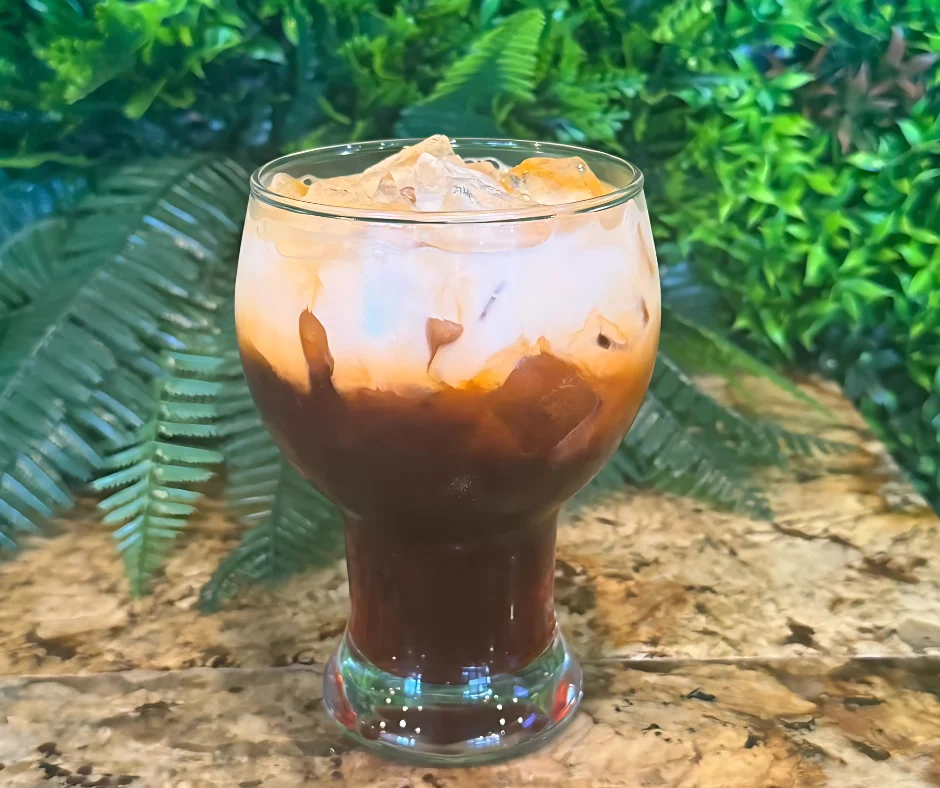 Iced coffee drink with layered espresso and cream