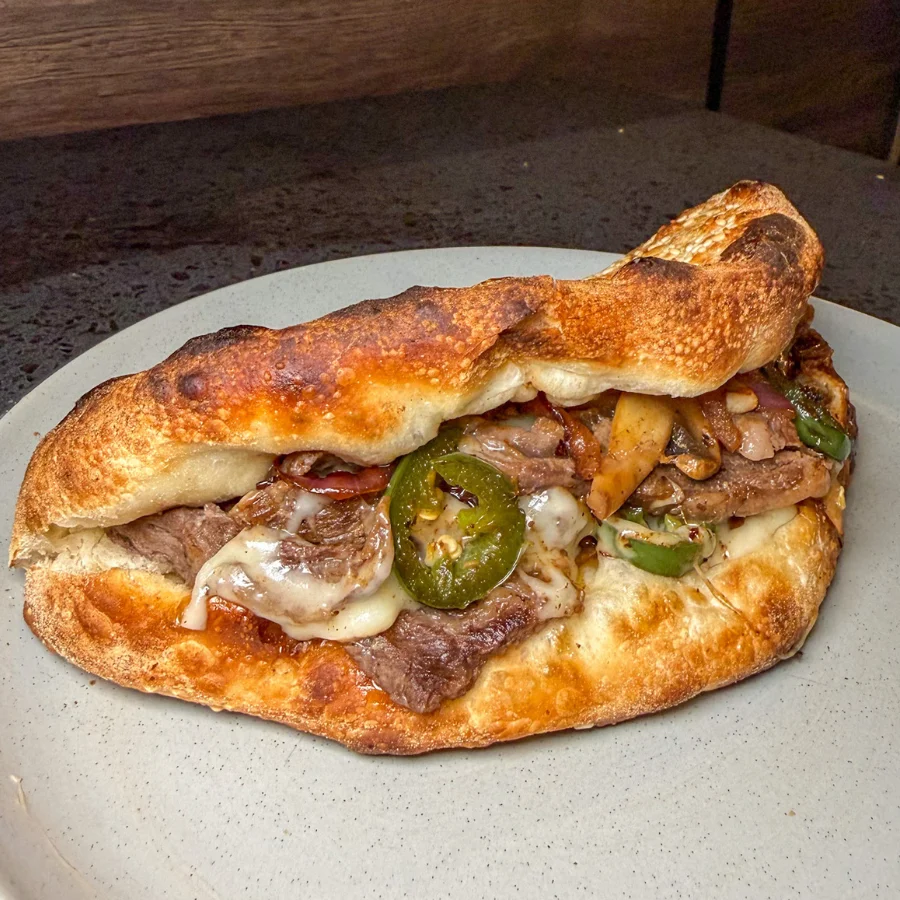 Delicious gourmet burger with fresh toppings on a wooden table