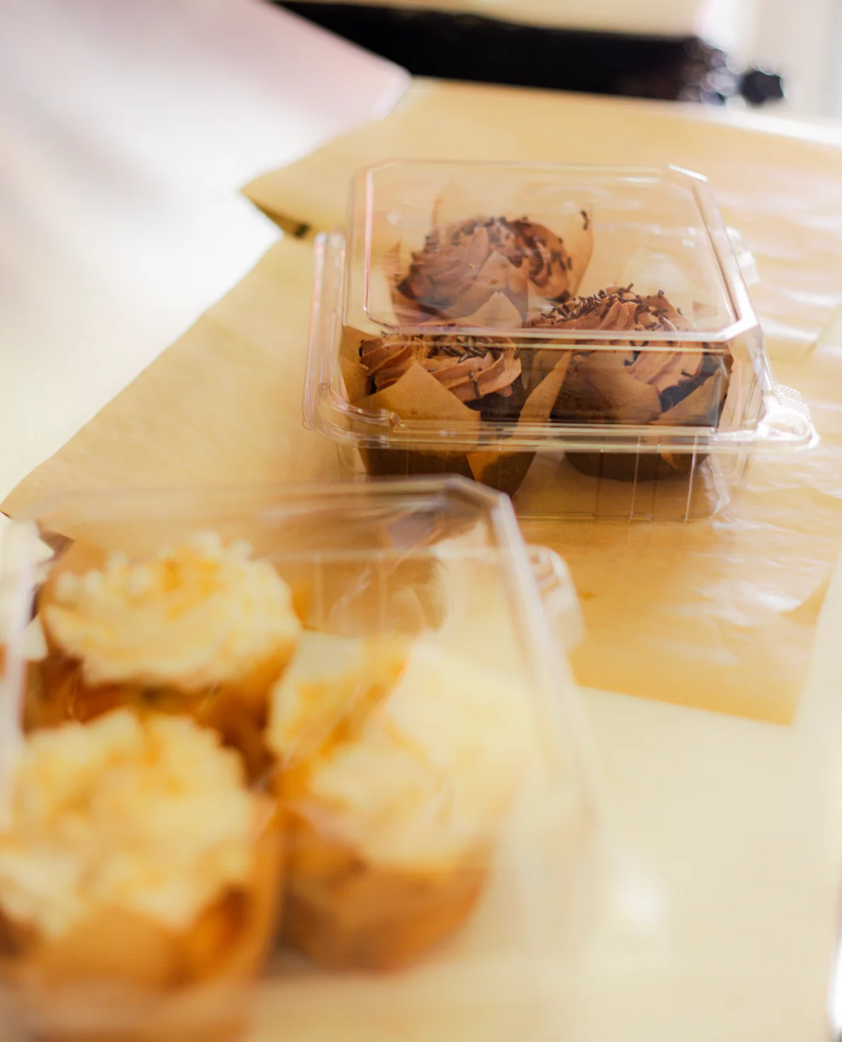 Assorted gourmet cupcakes in clear packaging