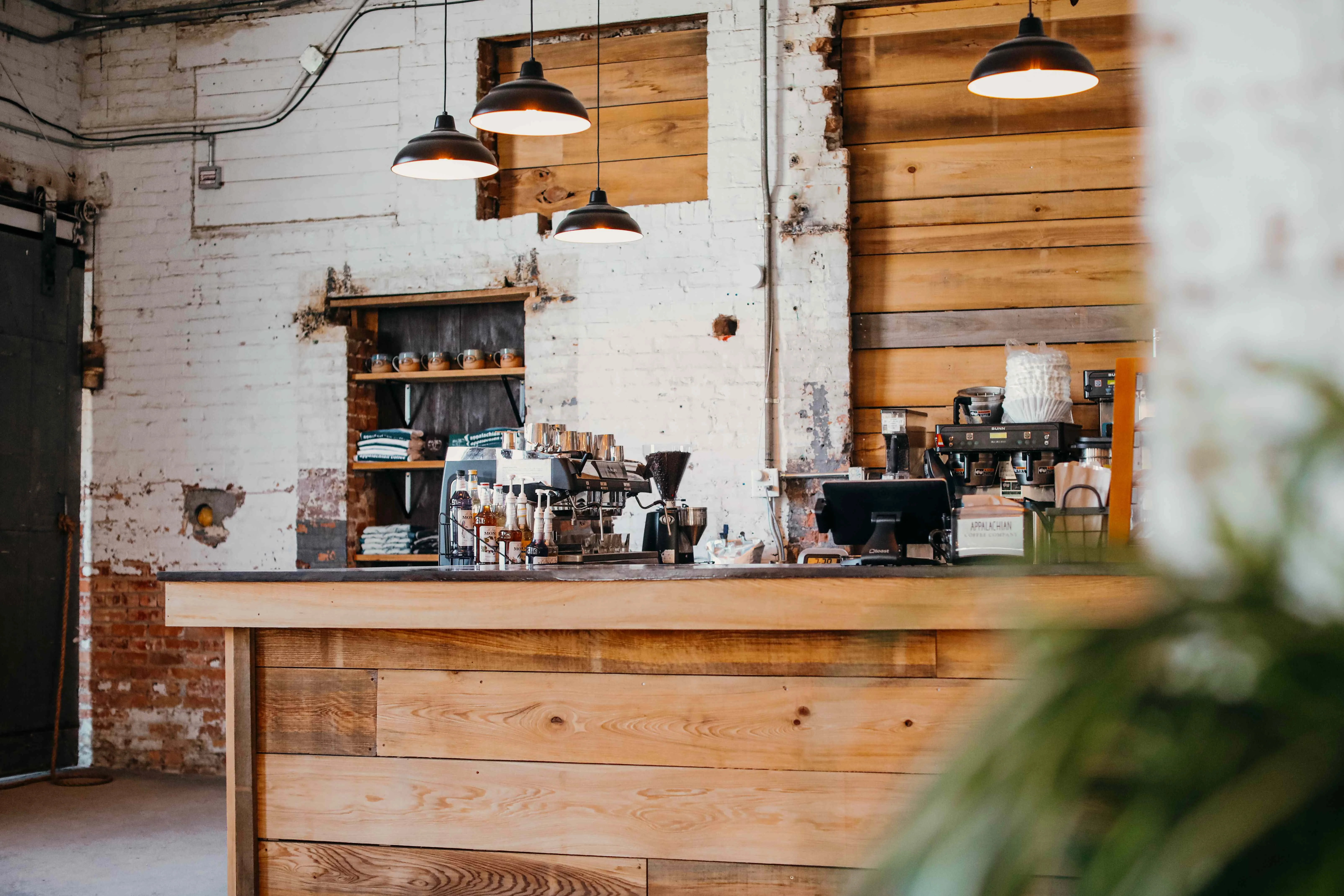 Cozy coffee shop interior with wooden counter and warm lighting