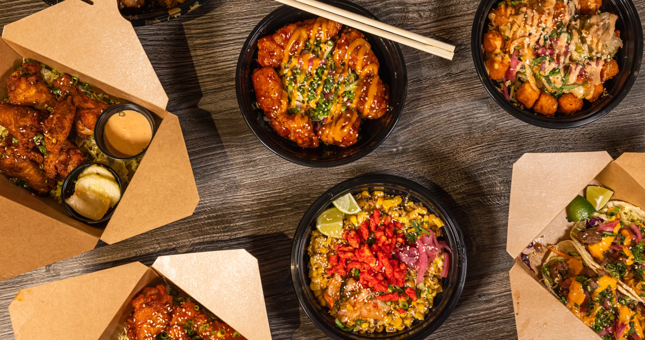 Variety of delicious Asian-inspired dishes in takeout containers.