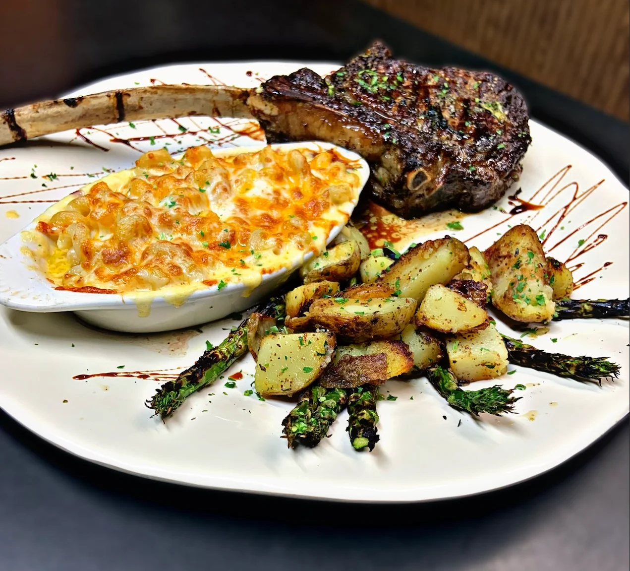 Grilled ribeye steak with mac and cheese and roasted vegetables
