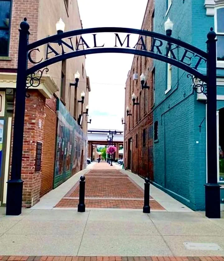 Entrance to Canal Market with brick pathway and colorful buildings