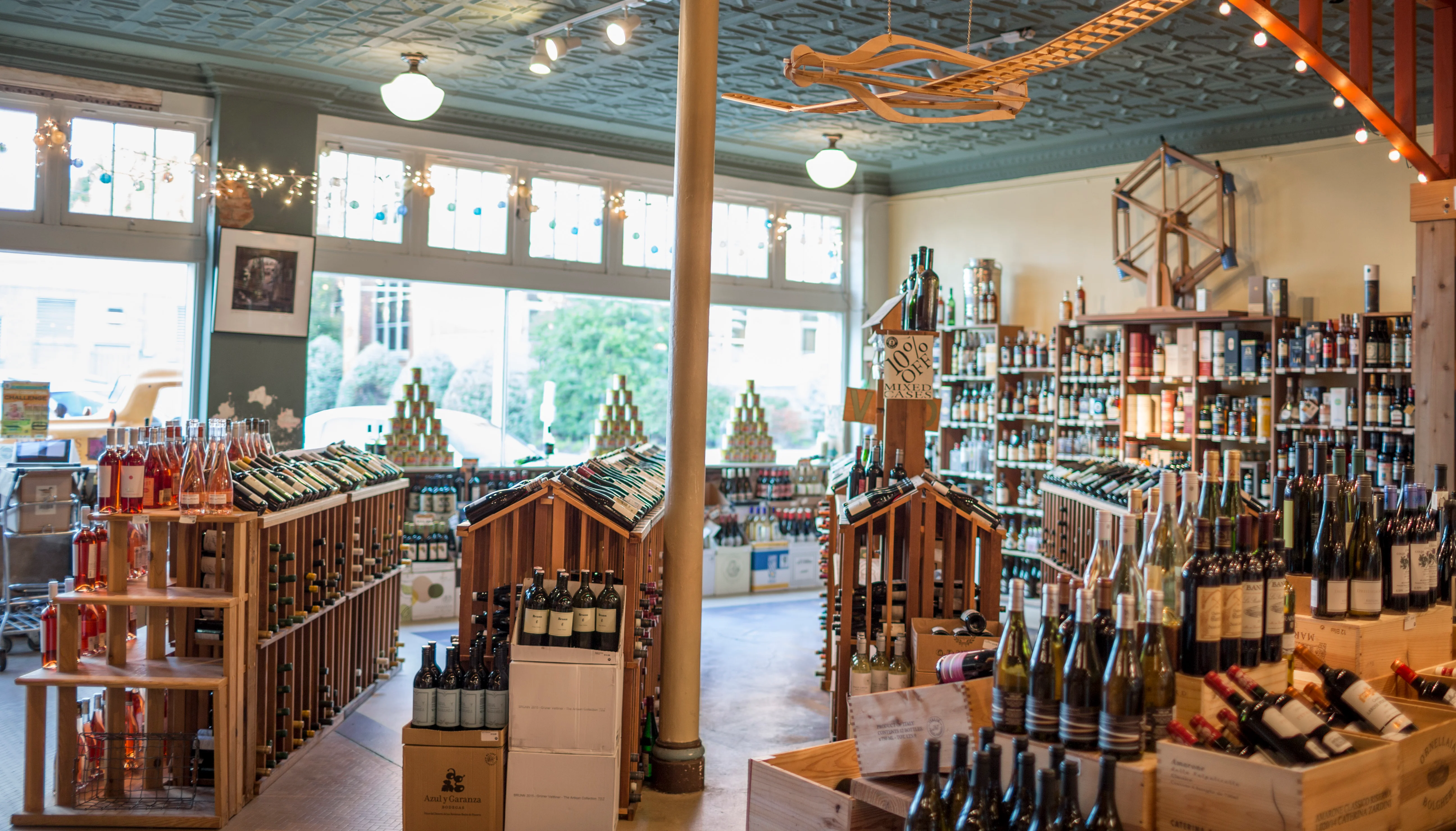 Stacks of bottles of wine and pyramids of Italian tomatoes shrouded under a cozy wooden arch in the front of our store.