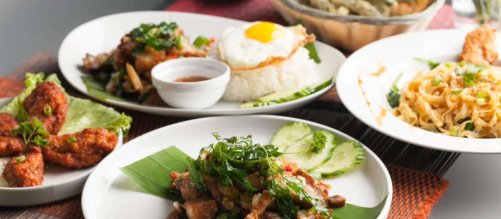 Assorted Thai dishes including pad thai and crispy chicken