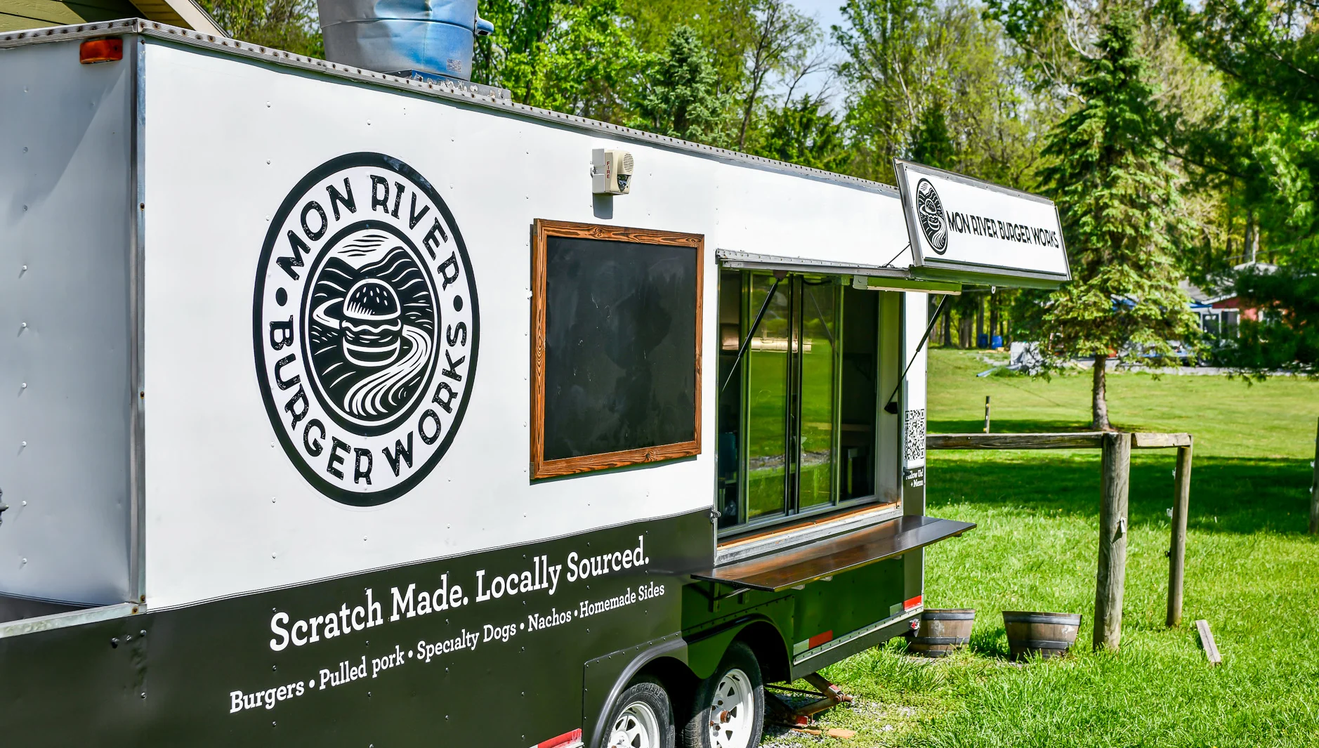Mon River Burger Works Trailer set up with green grass behind