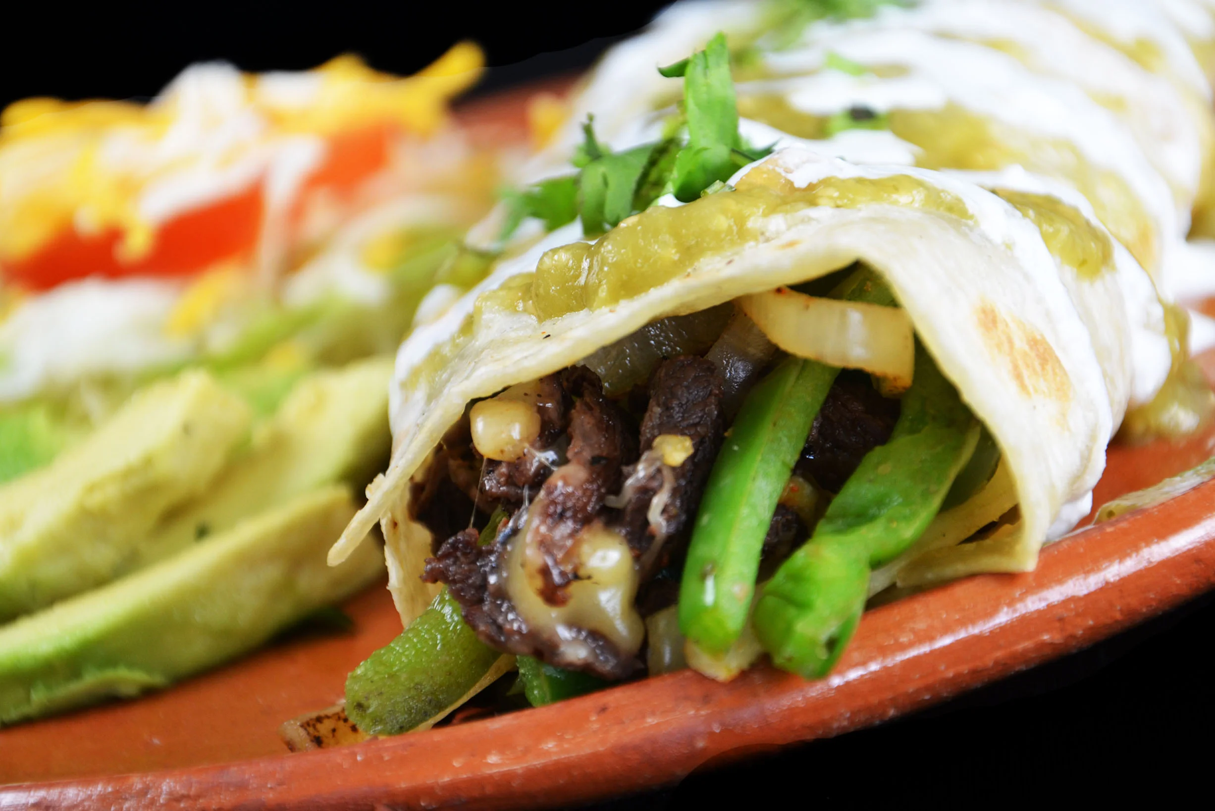Delicious Mexican enchiladas topped with green sauce