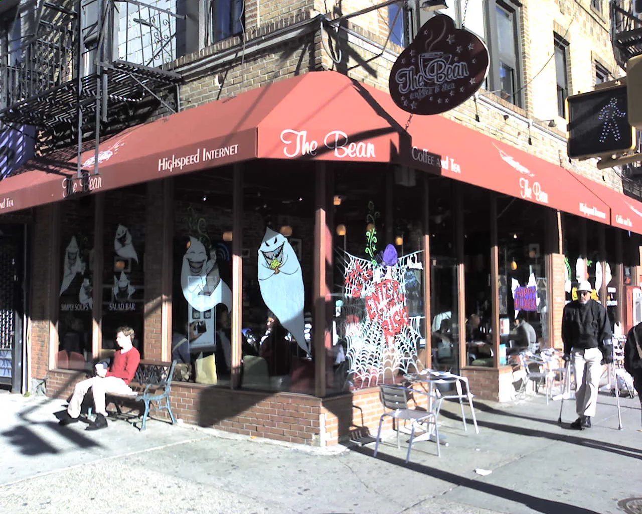 Charming coffee shop exterior with inviting seating and decorative window art