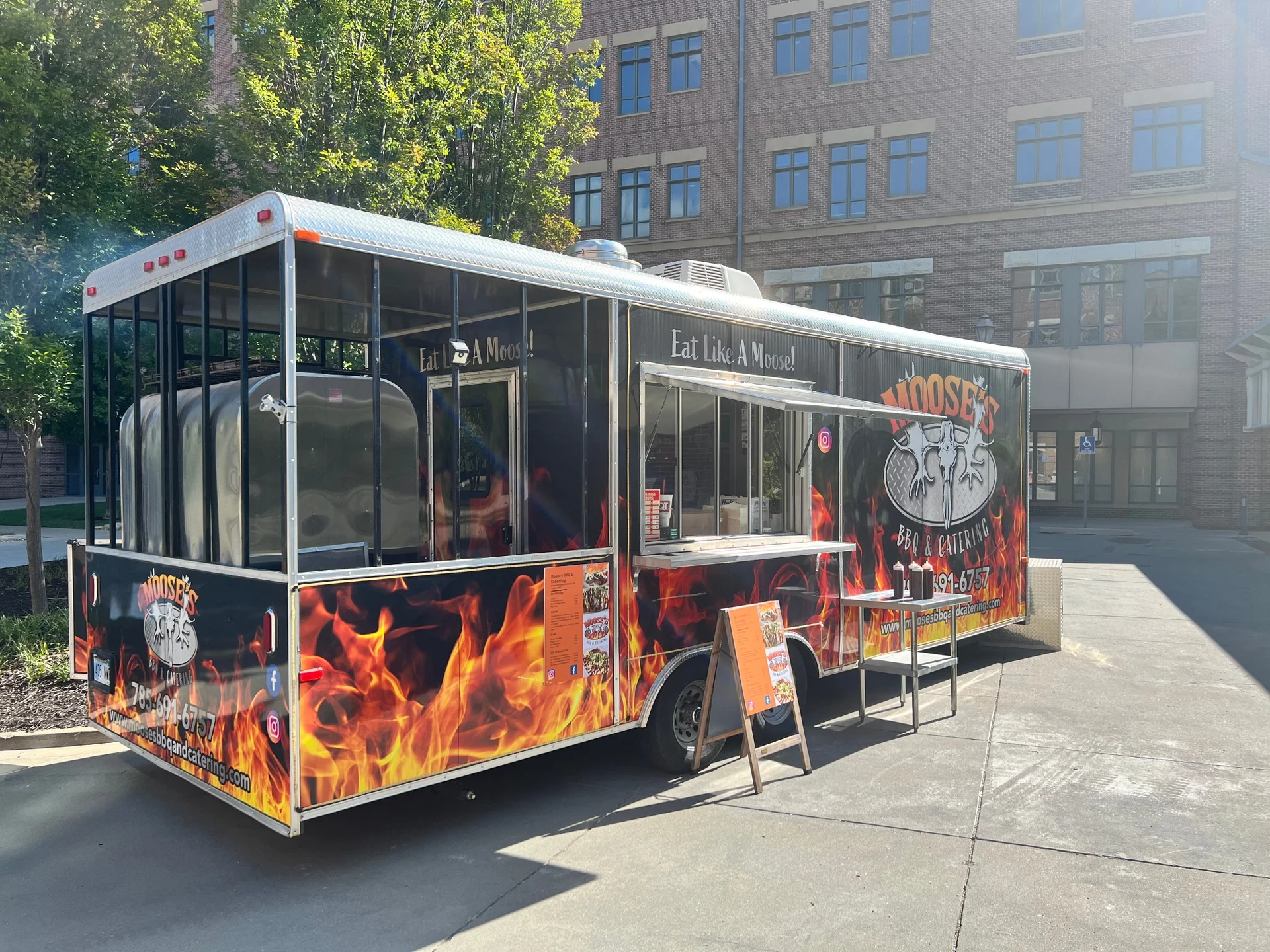 Food truck serving BBQ cuisine with vibrant flames design