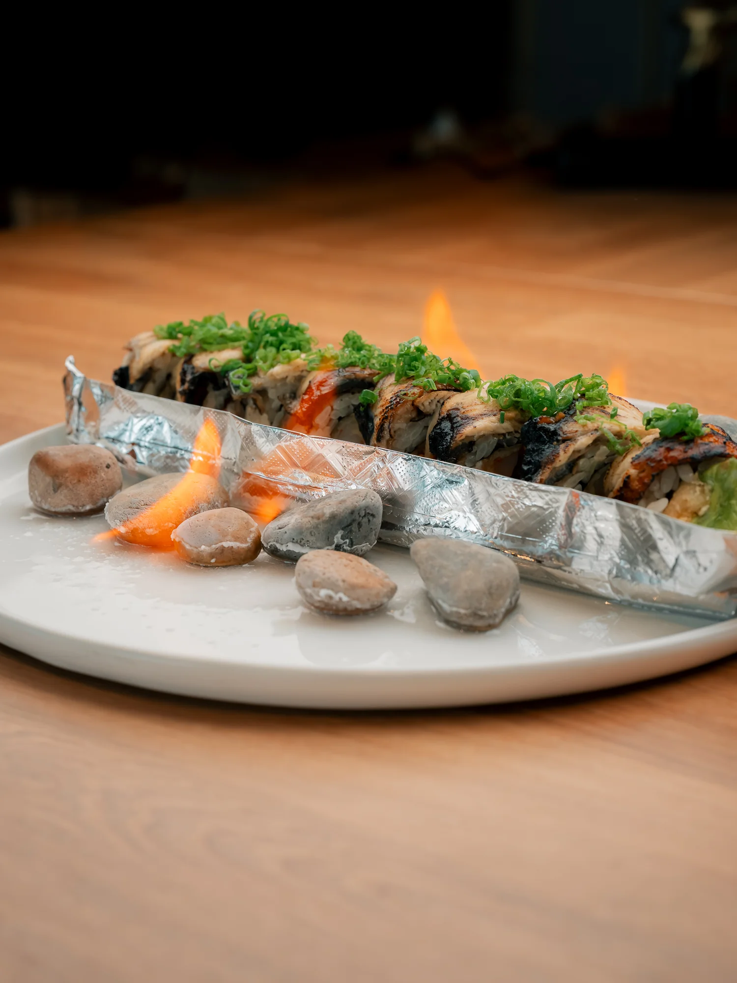 Flaming Japanese sushi roll served on a plate