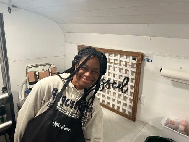 Smiling barista in a cozy coffee shop
