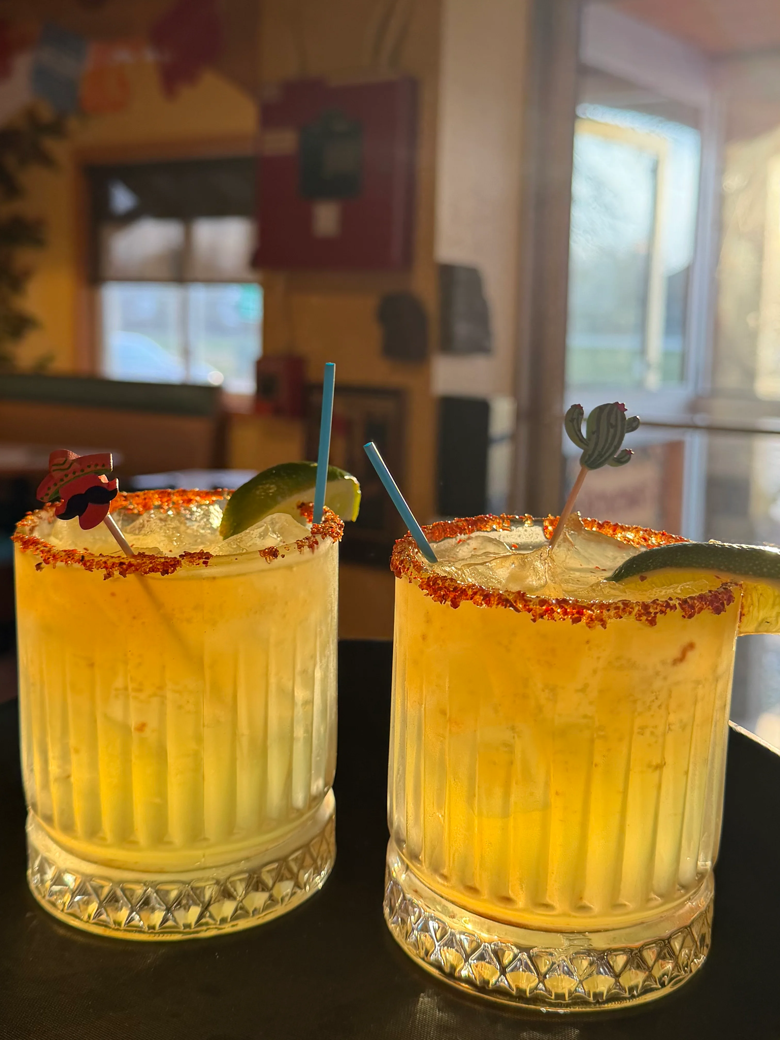 Refreshing margaritas served on a tray with vibrant garnishes