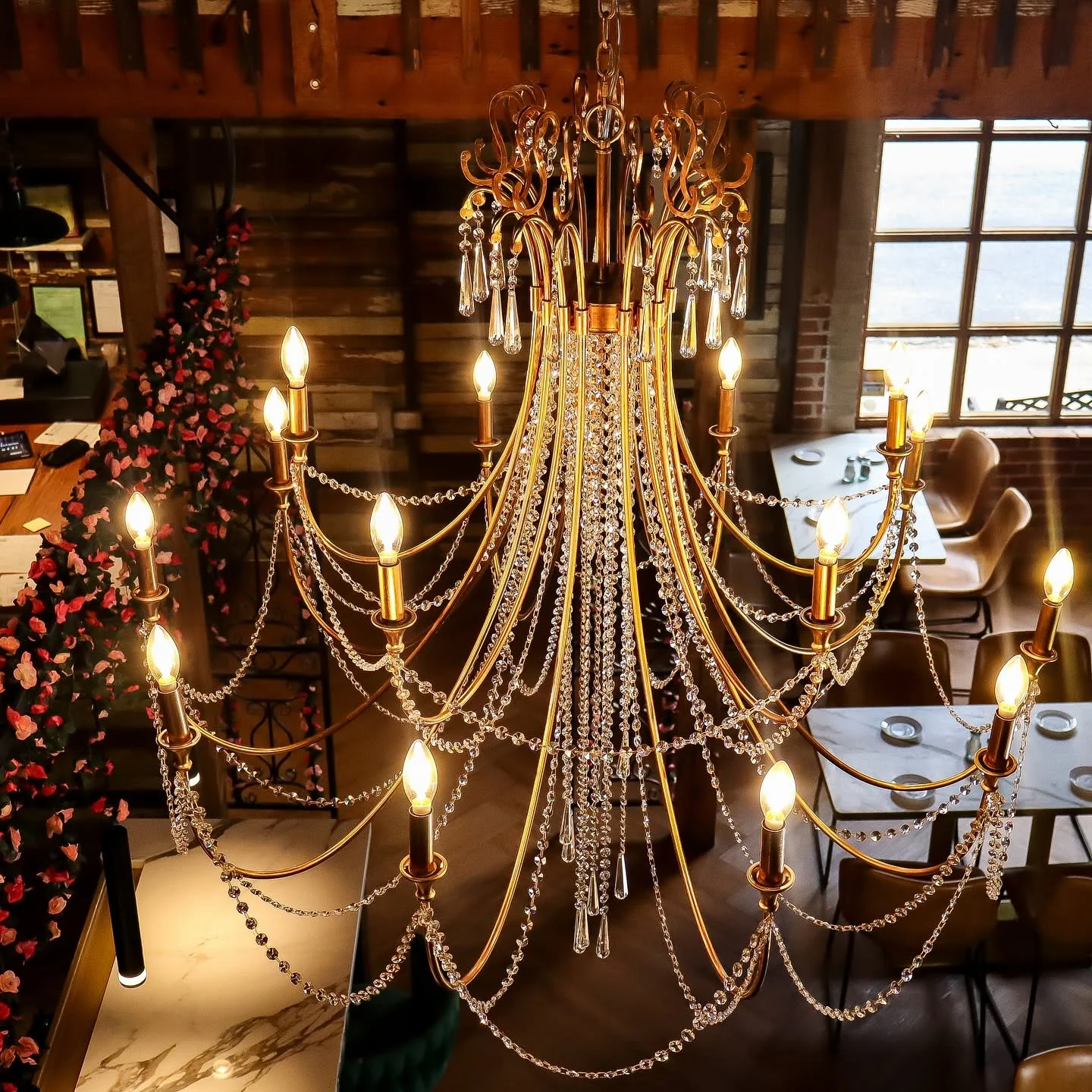 Elegant chandelier illuminating a cozy restaurant interior