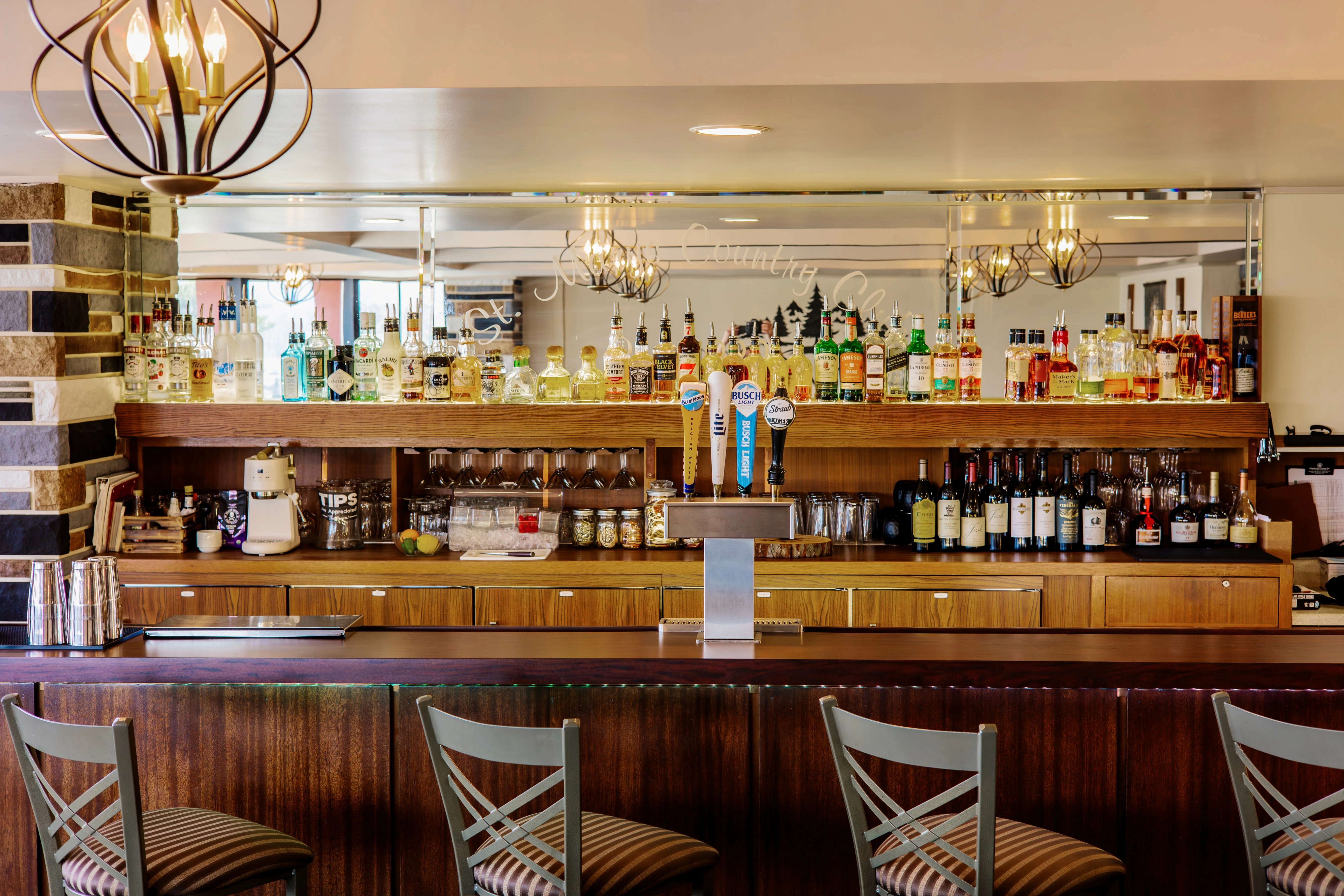 Modern bar counter with a variety of spirits and beer taps