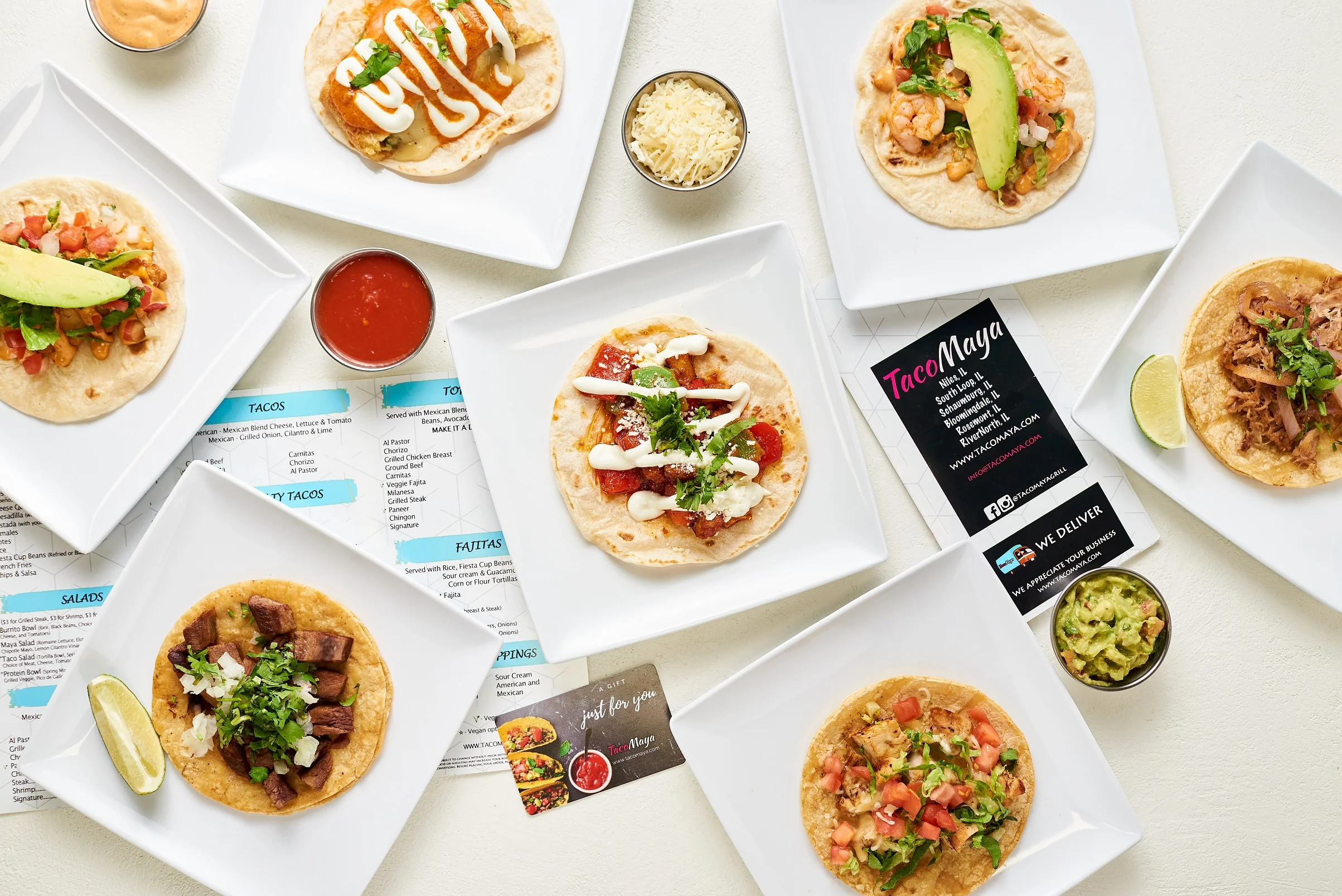 Assorted Mexican tacos with fresh toppings and salsas