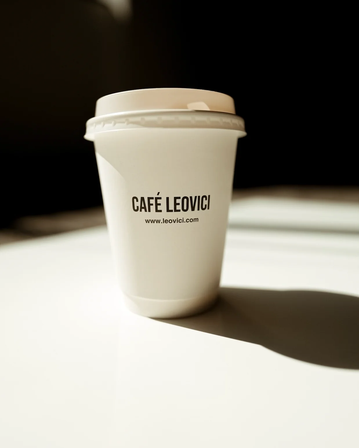 Coffee cup from Café Leovici on a bright table