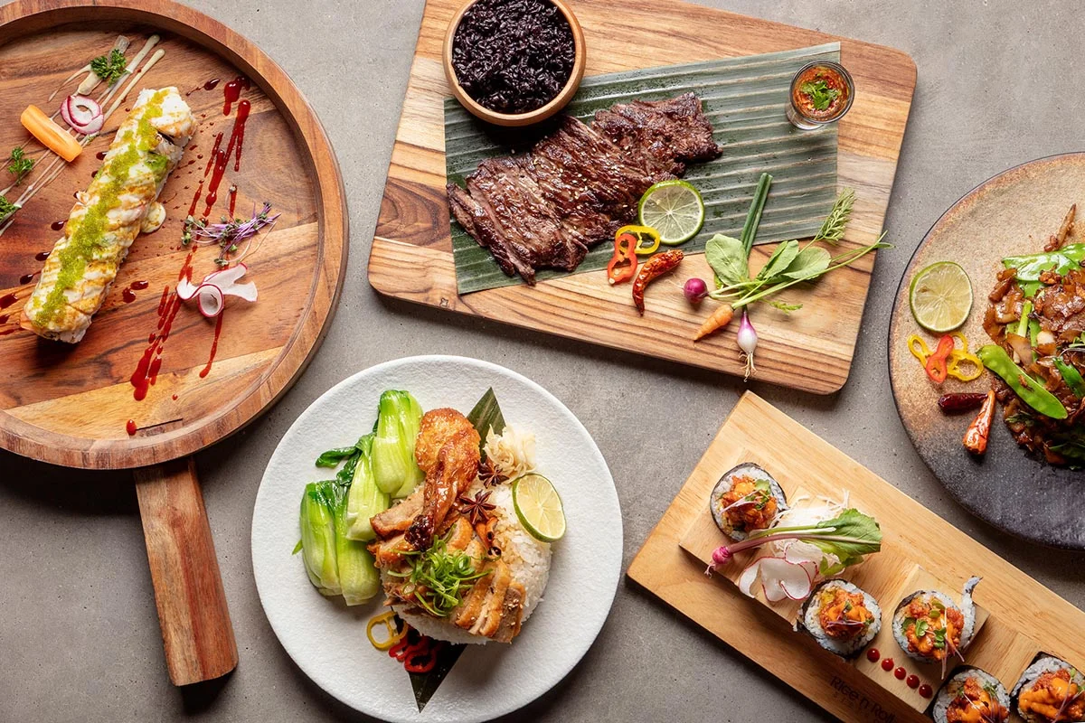 Assorted Asian dishes including sushi and grilled beef